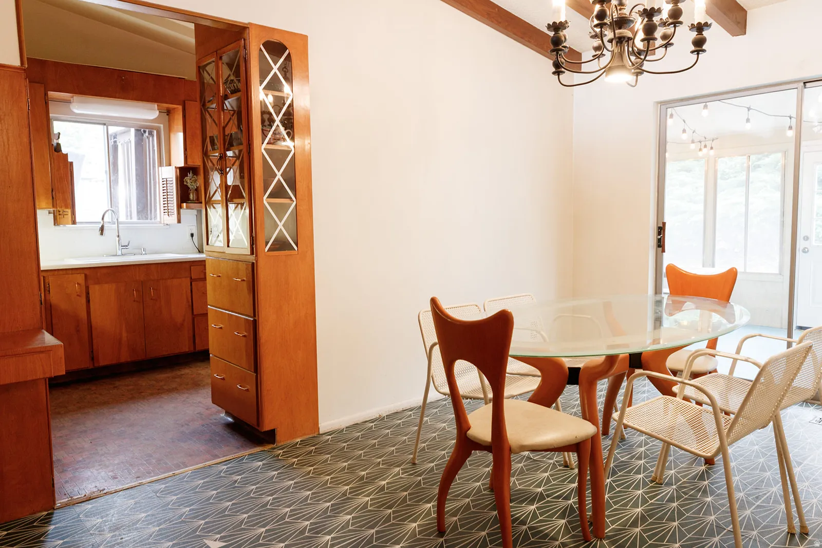 Dining space featuring hanging lights, dark carpet, and vaulted ceiling