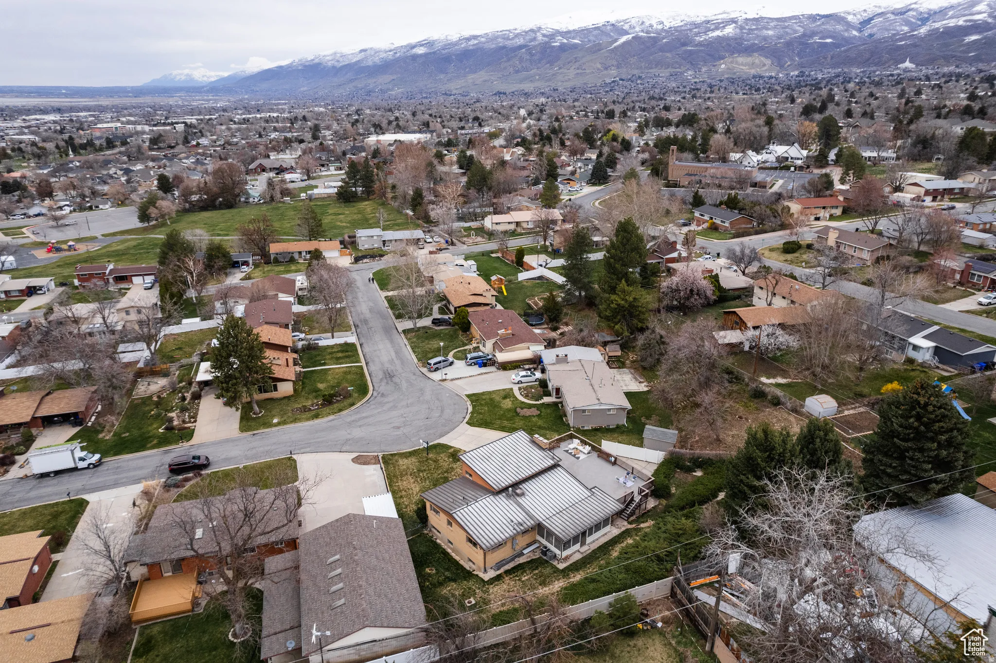 Aerial perspective of suburban area with a mountainous background