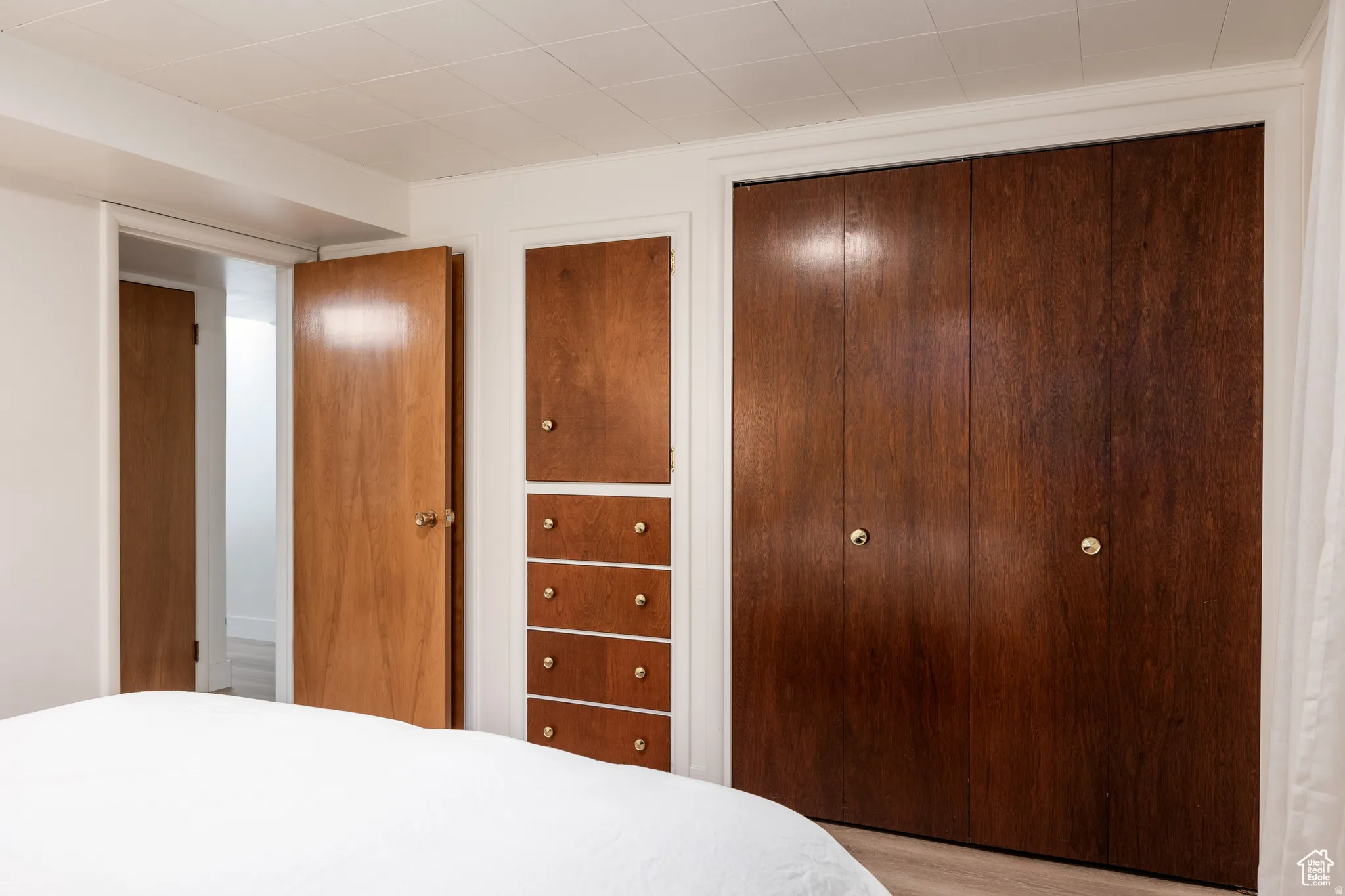 Bedroom with a closet and light wood finished floors