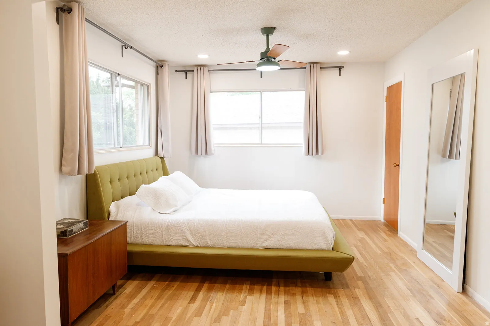 Bedroom with light wood finished floors, ceiling fan, a textured ceiling, and recessed lighting