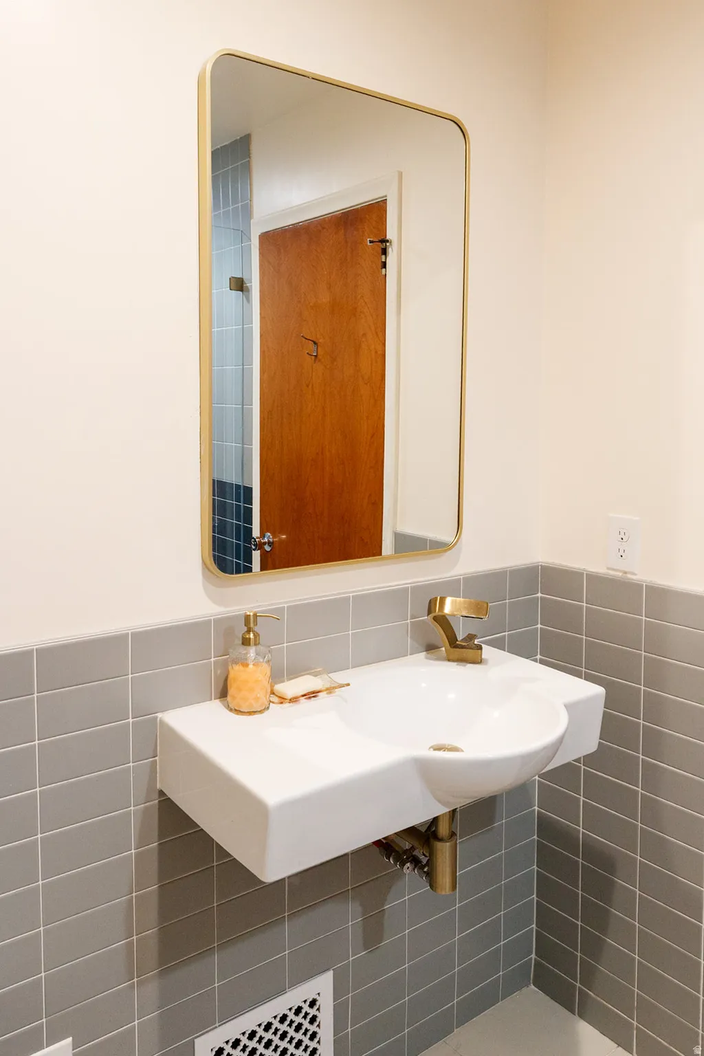 Bathroom with tile walls and a wainscoted wall