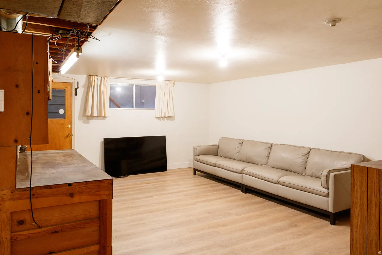 Living area with light wood-type flooring and baseboards