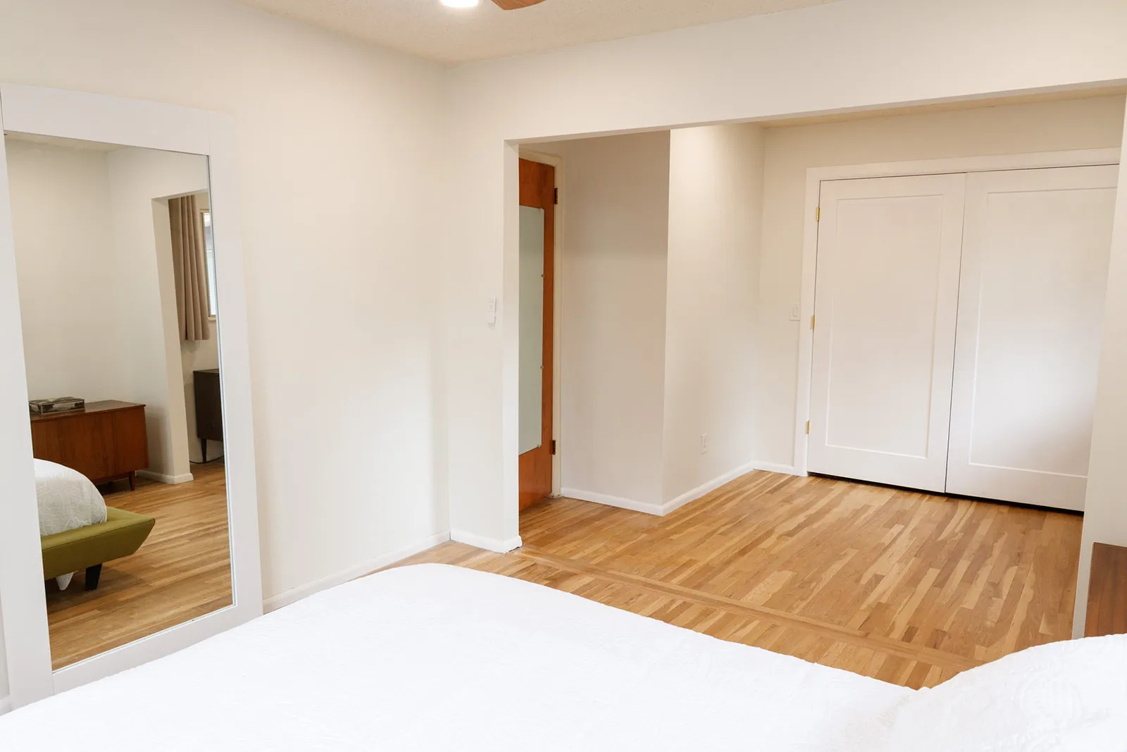 Unfurnished bedroom with light wood-style floors and a closet