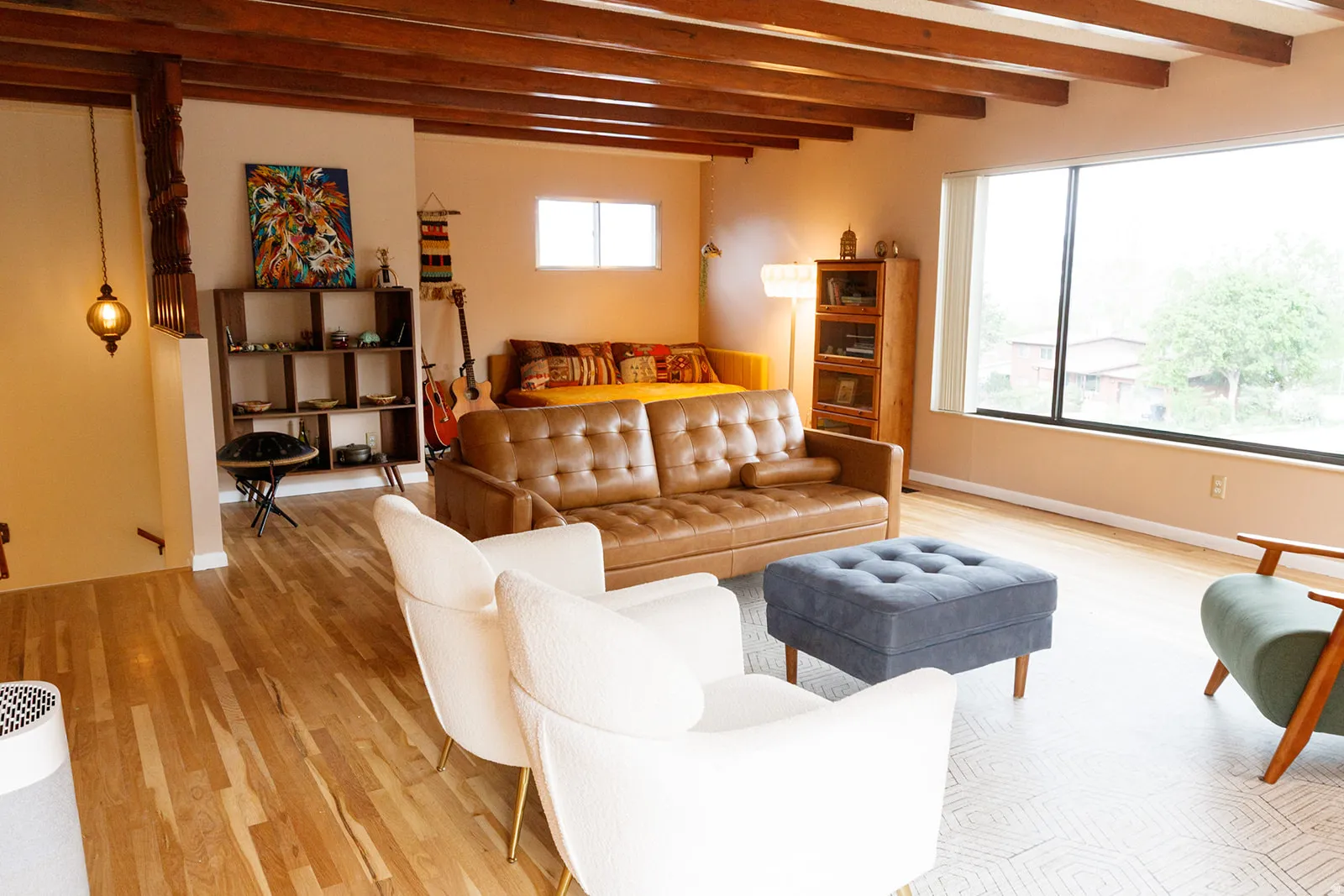 Living area with light wood-type flooring and beam ceiling