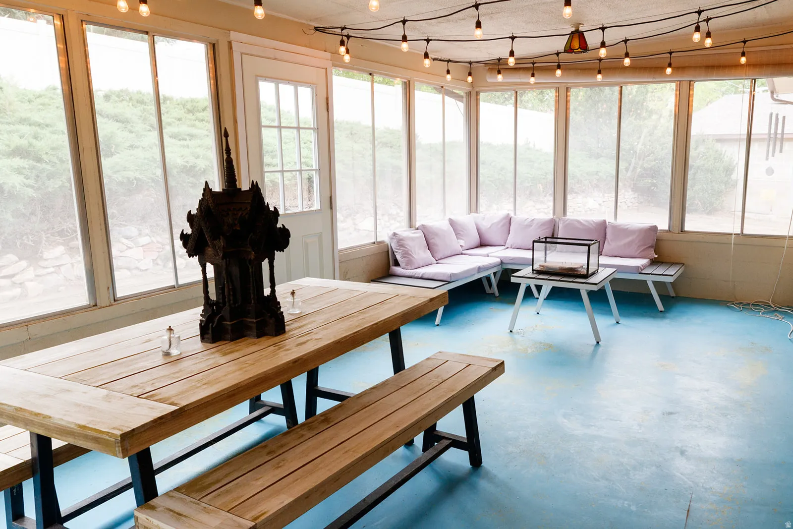 Sunroom featuring concrete flooring and healthy amount of natural light
