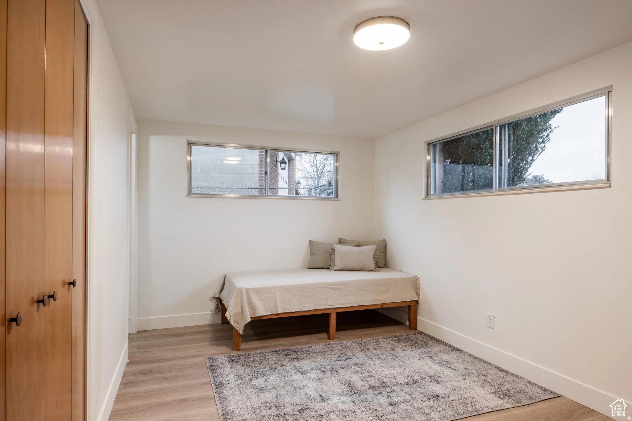 Bedroom with light wood-style floors and a closet