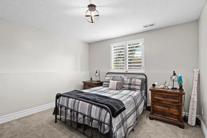 Bedroom with carpet flooring and a textured ceiling
