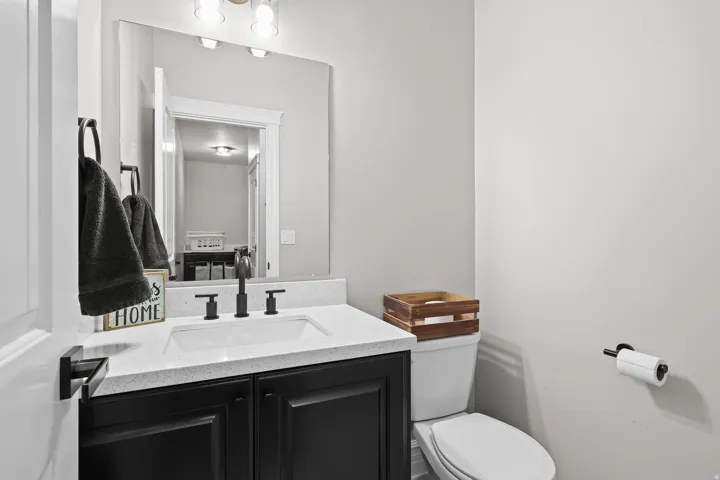 Half bathroom featuring vanity and toilet