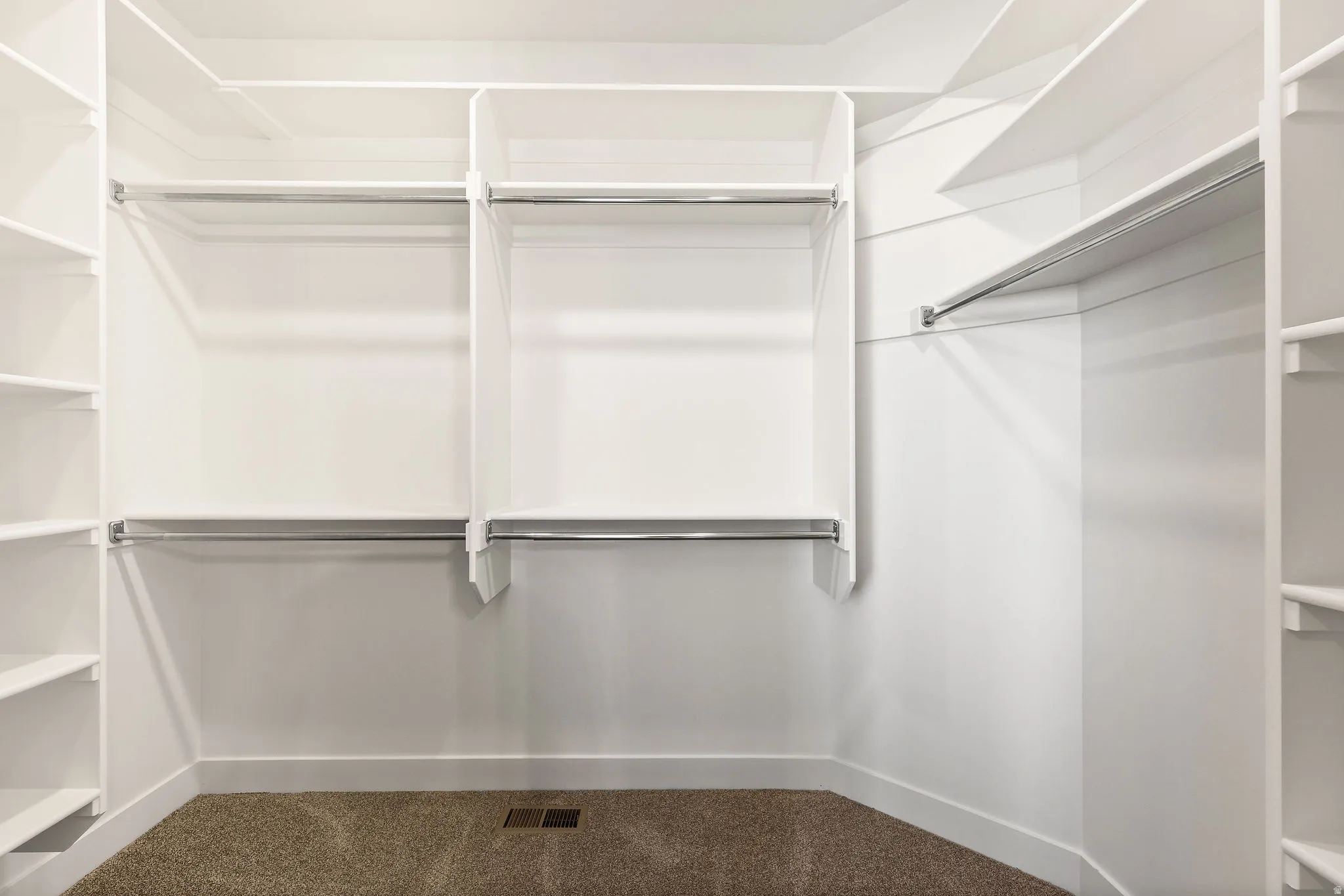 Walk in closet with carpet floors
