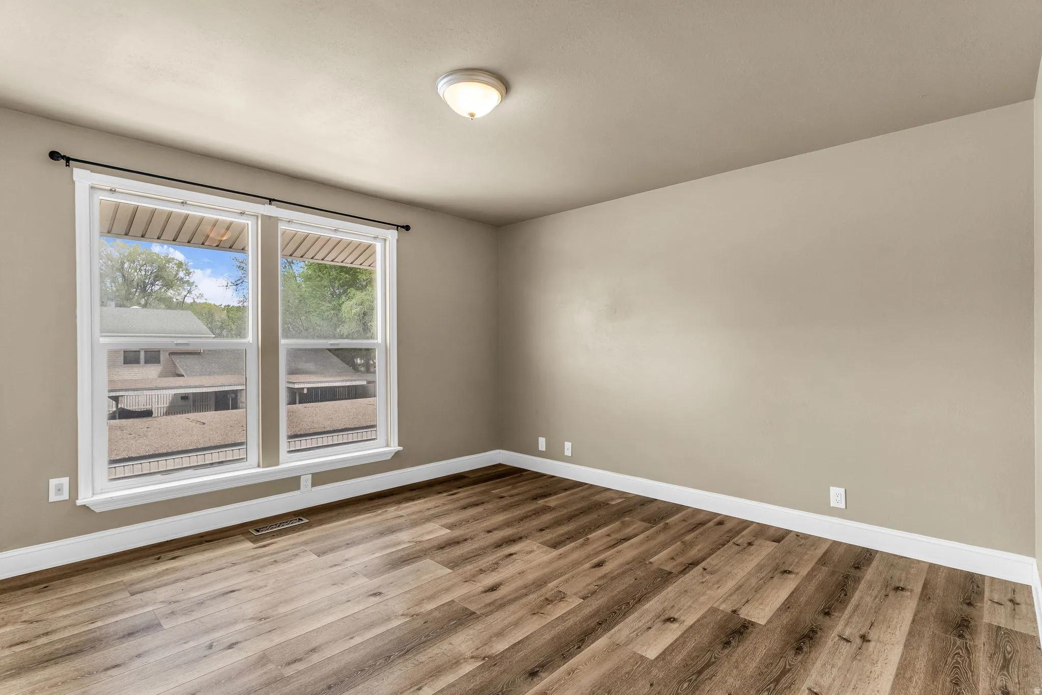 Unfurnished room featuring light wood-style flooring and baseboards