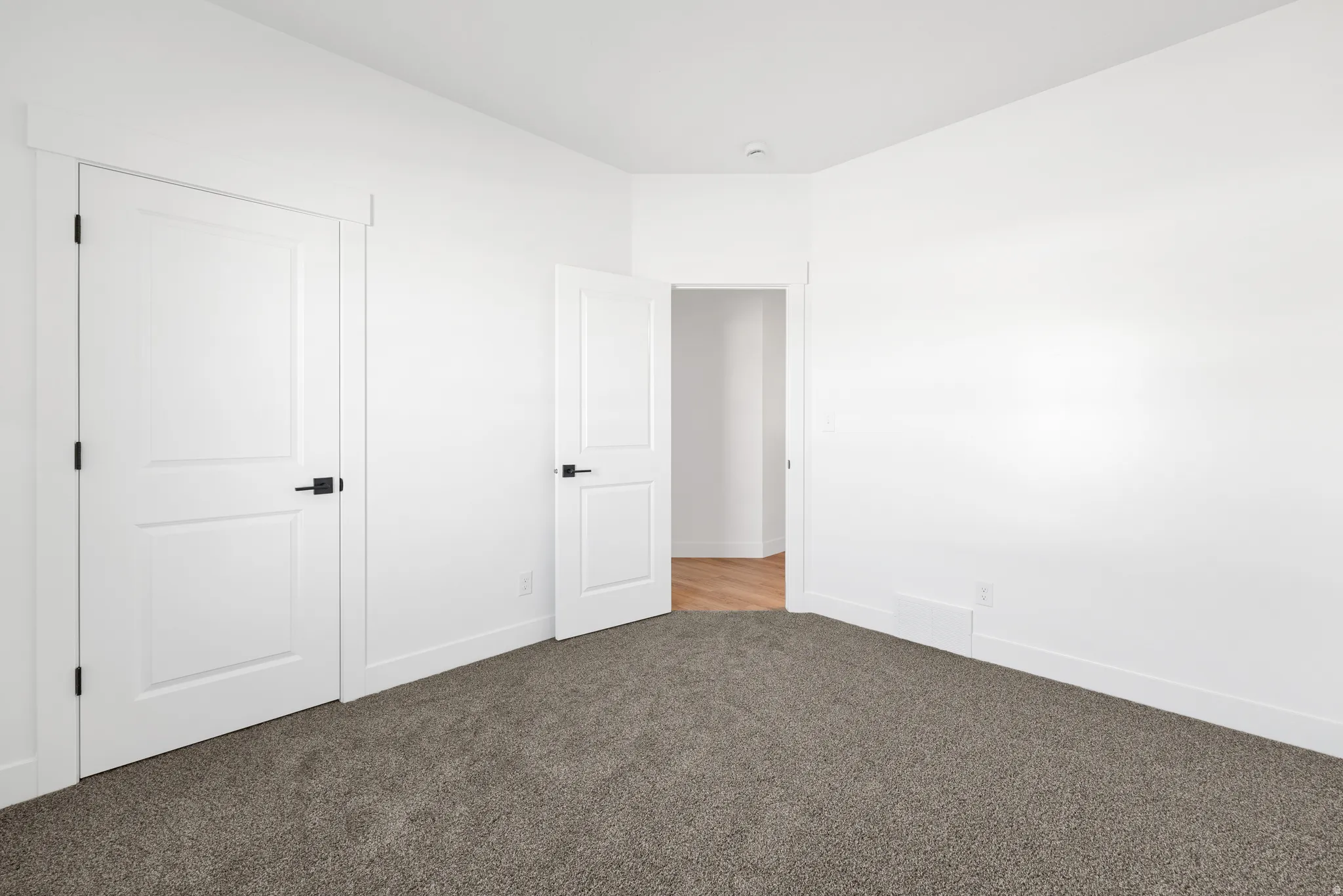 Unfurnished bedroom with carpet and baseboards