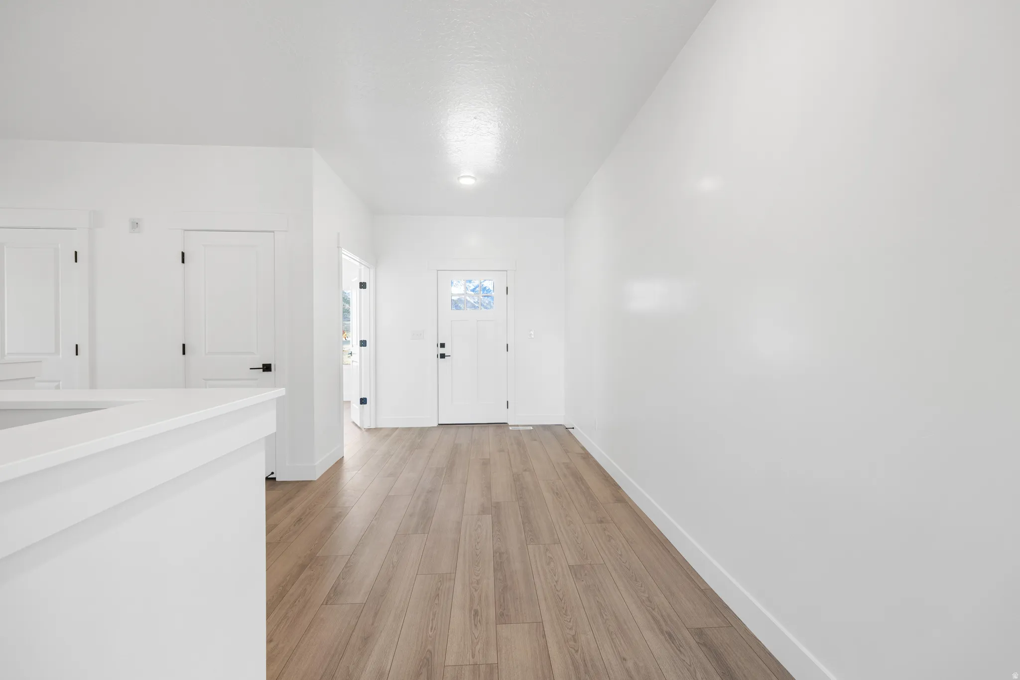 Foyer featuring baseboards and light wood-type flooring