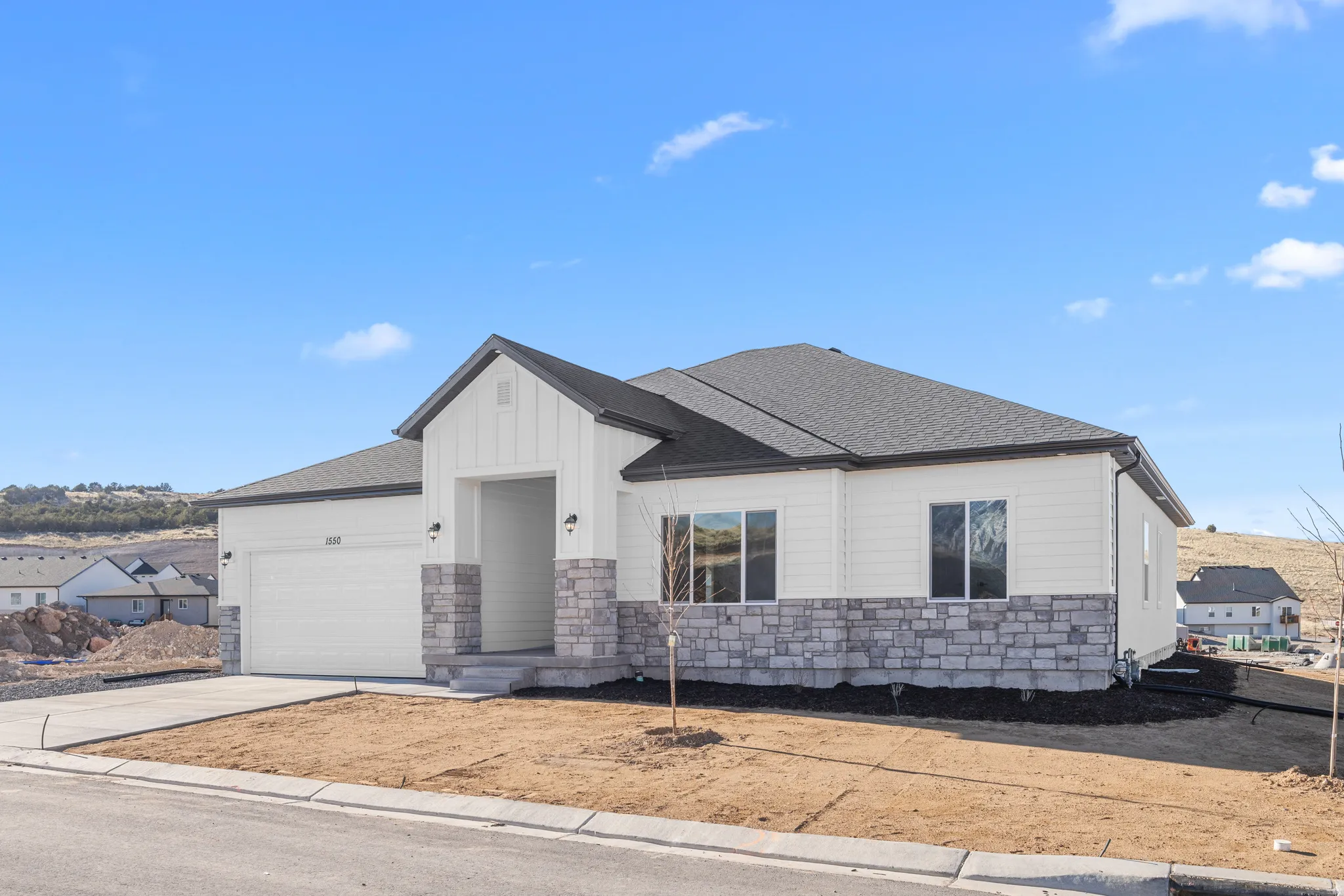 Modern inspired farmhouse featuring stone siding, an attached garage, roof with shingles, and concrete driveway