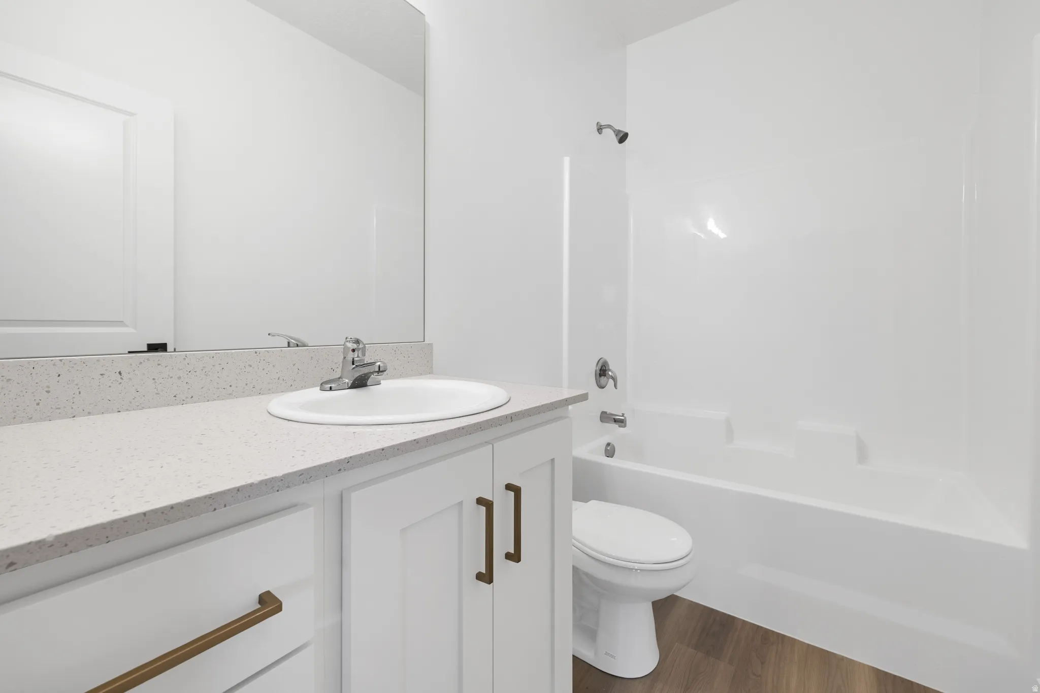 Full bathroom featuring vanity, dark wood finished floors, and washtub / shower combination