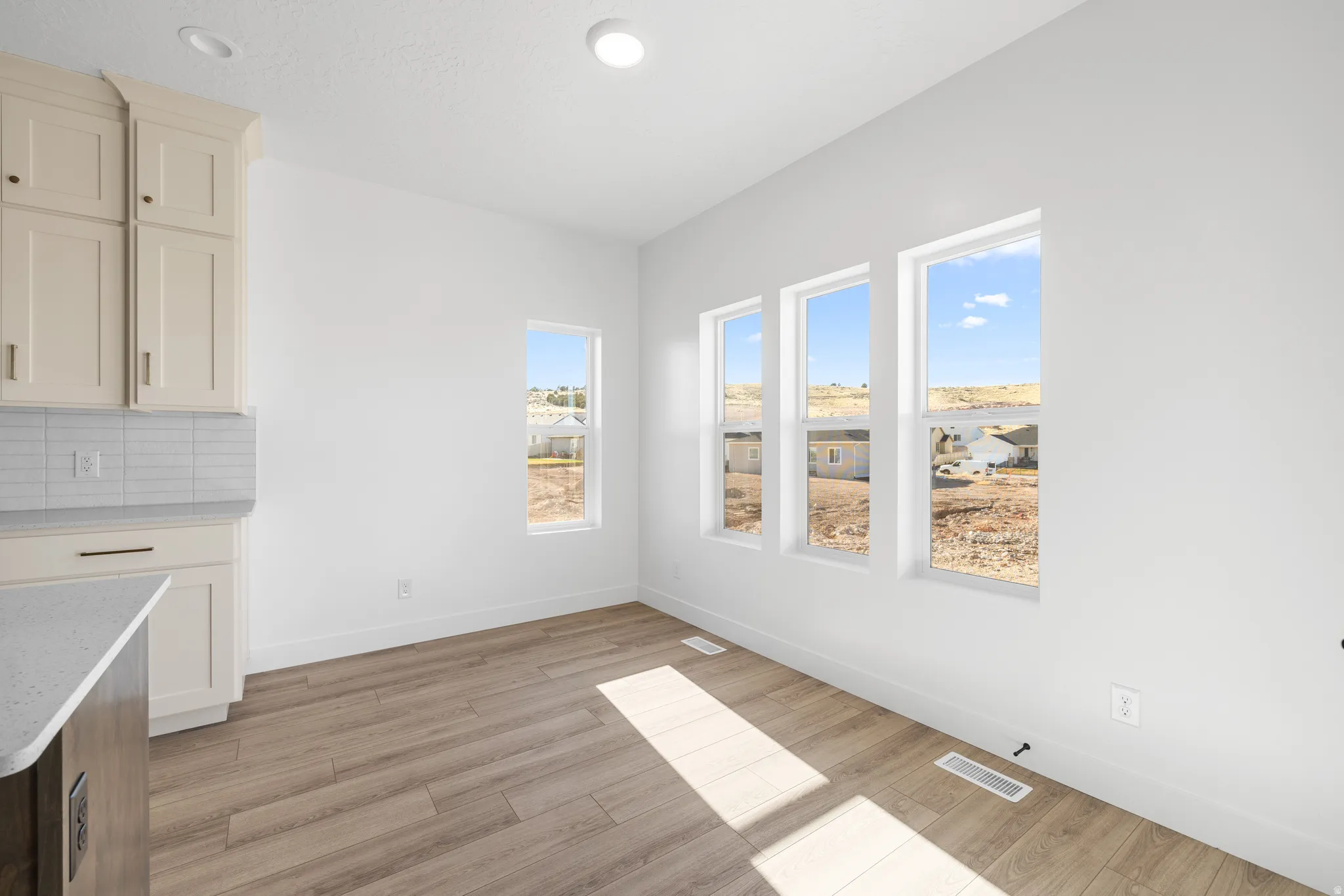 Unfurnished dining area featuring light wood finished floors and recessed lighting