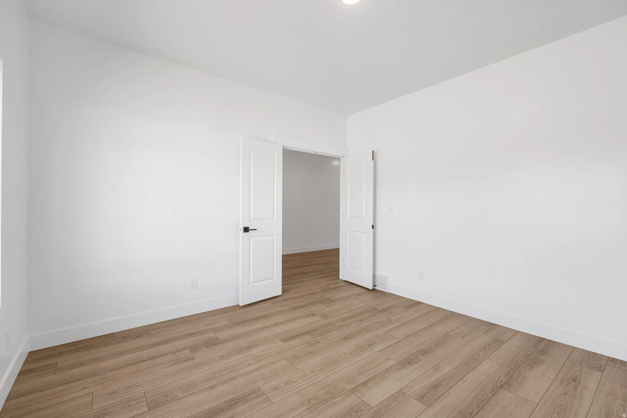 Unfurnished room with light wood-style flooring