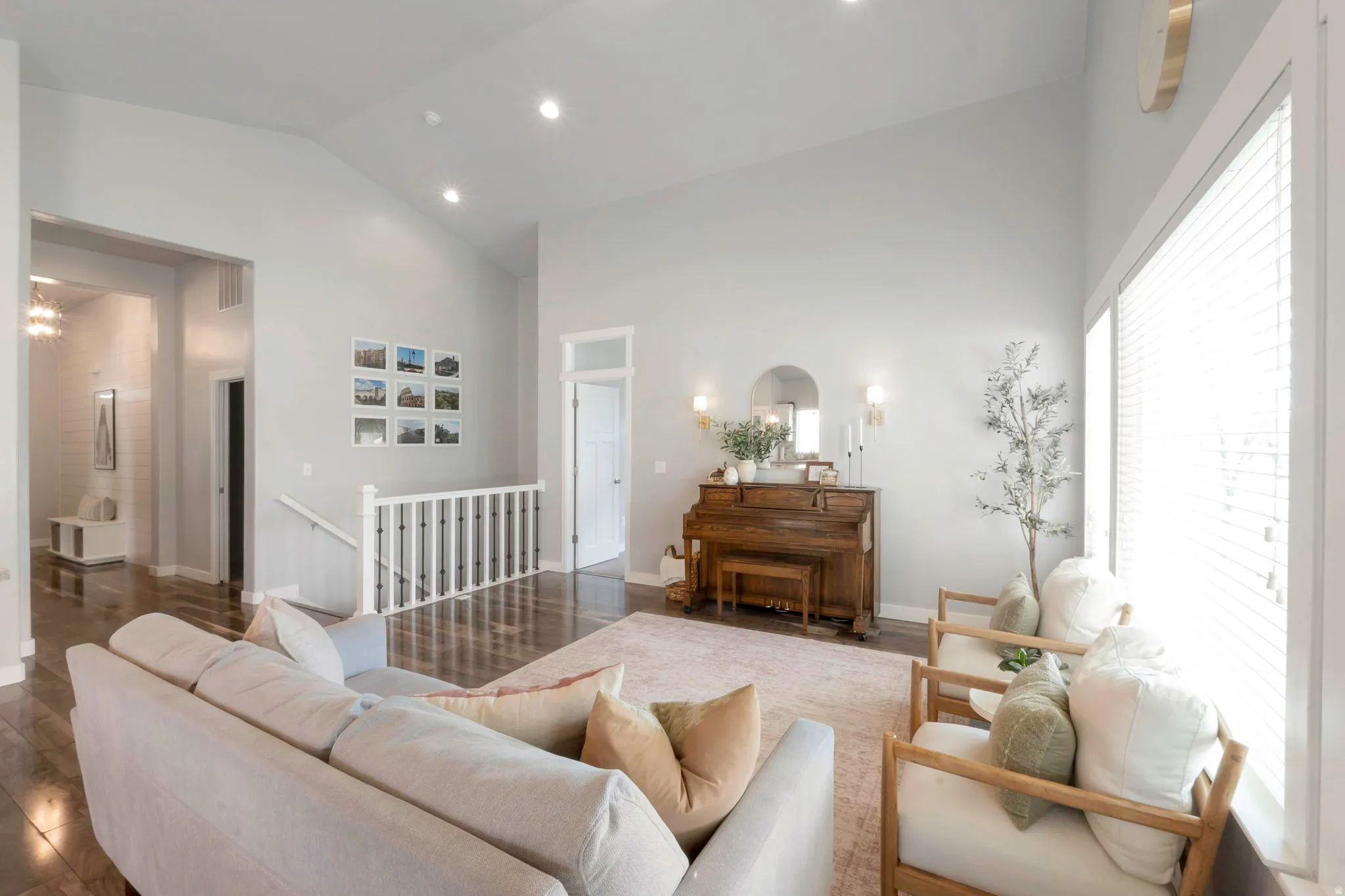 Living room with lofted ceiling, wood finished floors, and recessed lighting