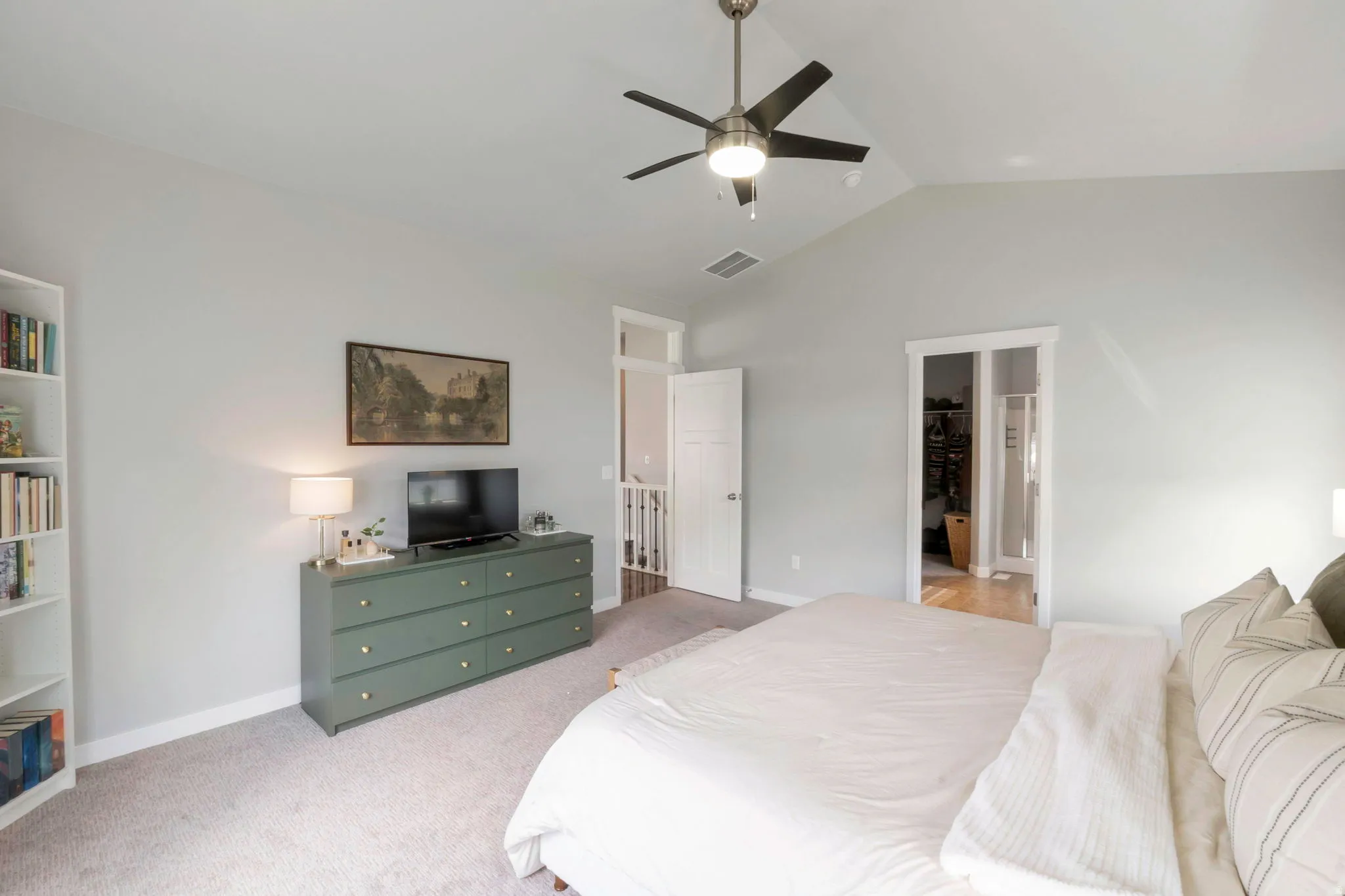 Bedroom with light colored carpet and ceiling fan