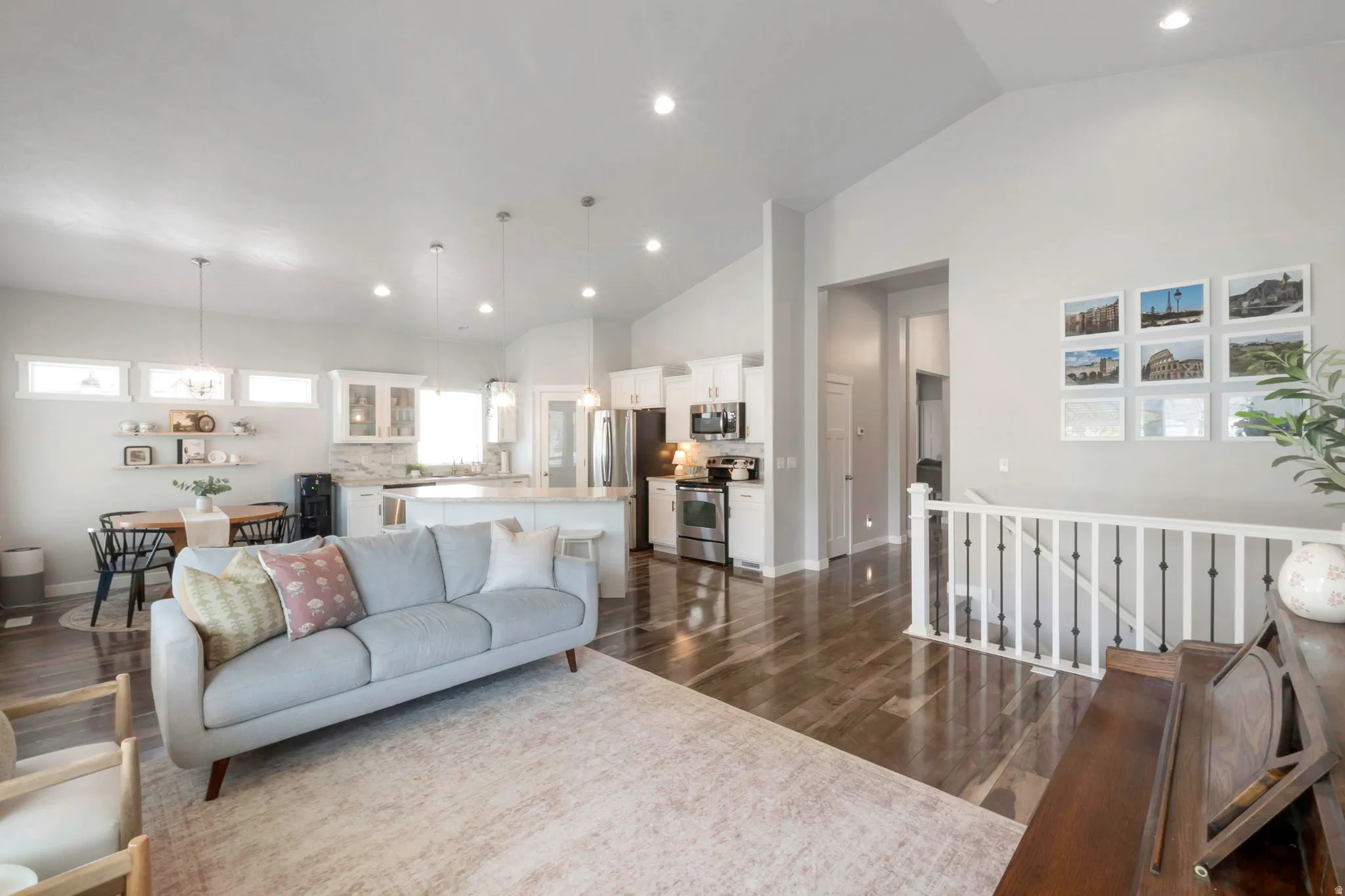 Living room featuring lofted ceiling, recessed lighting, and dark wood-type flooring