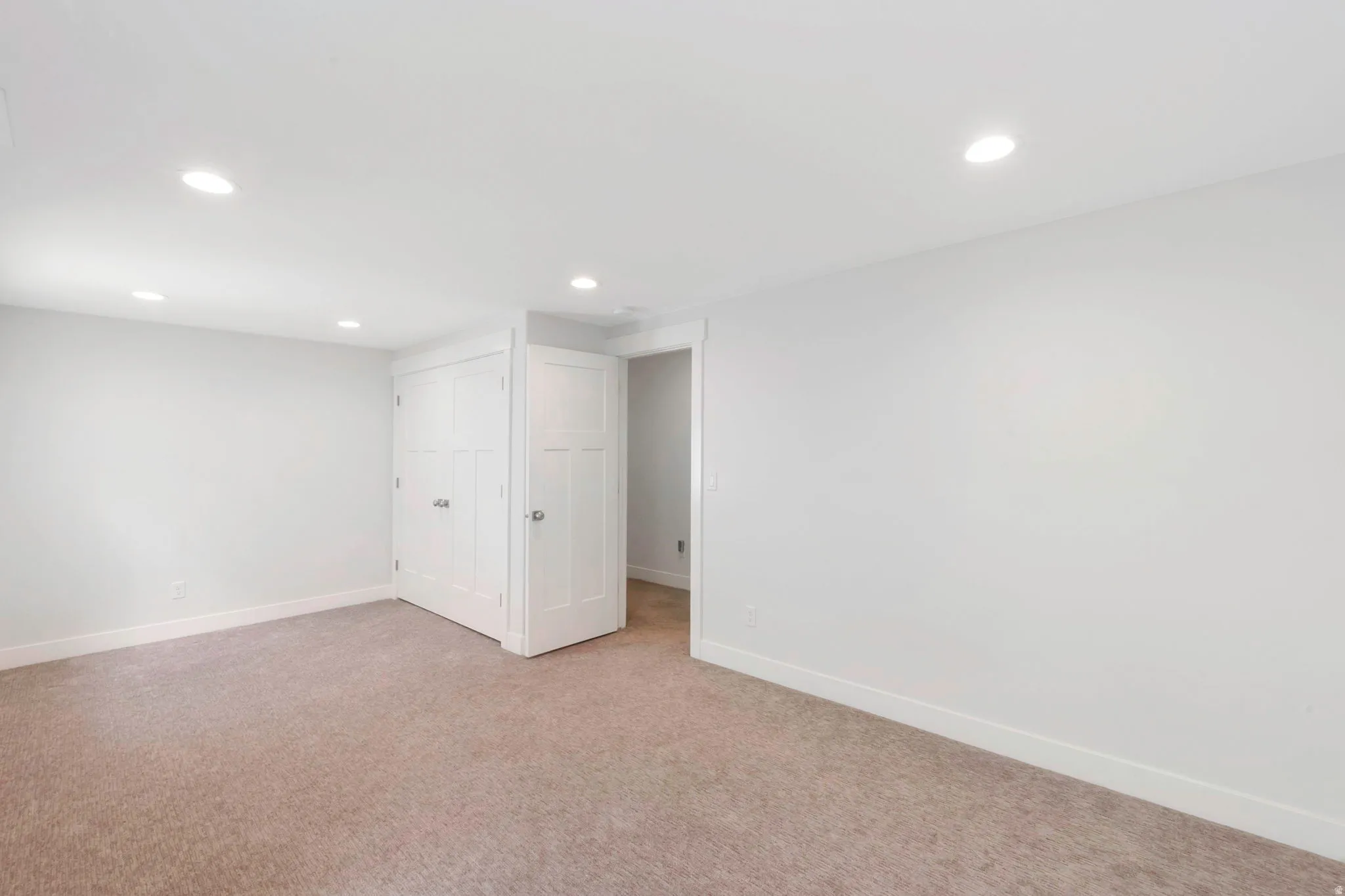Basement featuring recessed lighting and light carpet