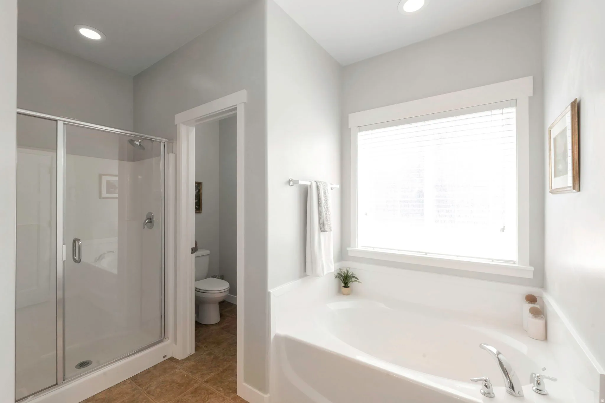 Bathroom with a shower stall, a garden tub, light tile patterned floors, and recessed lighting