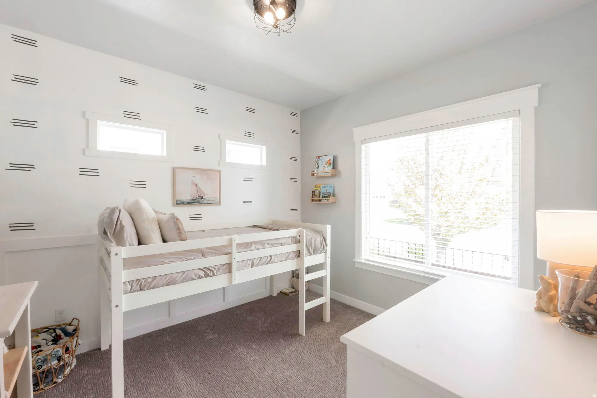 Bedroom with multiple windows and dark colored carpet