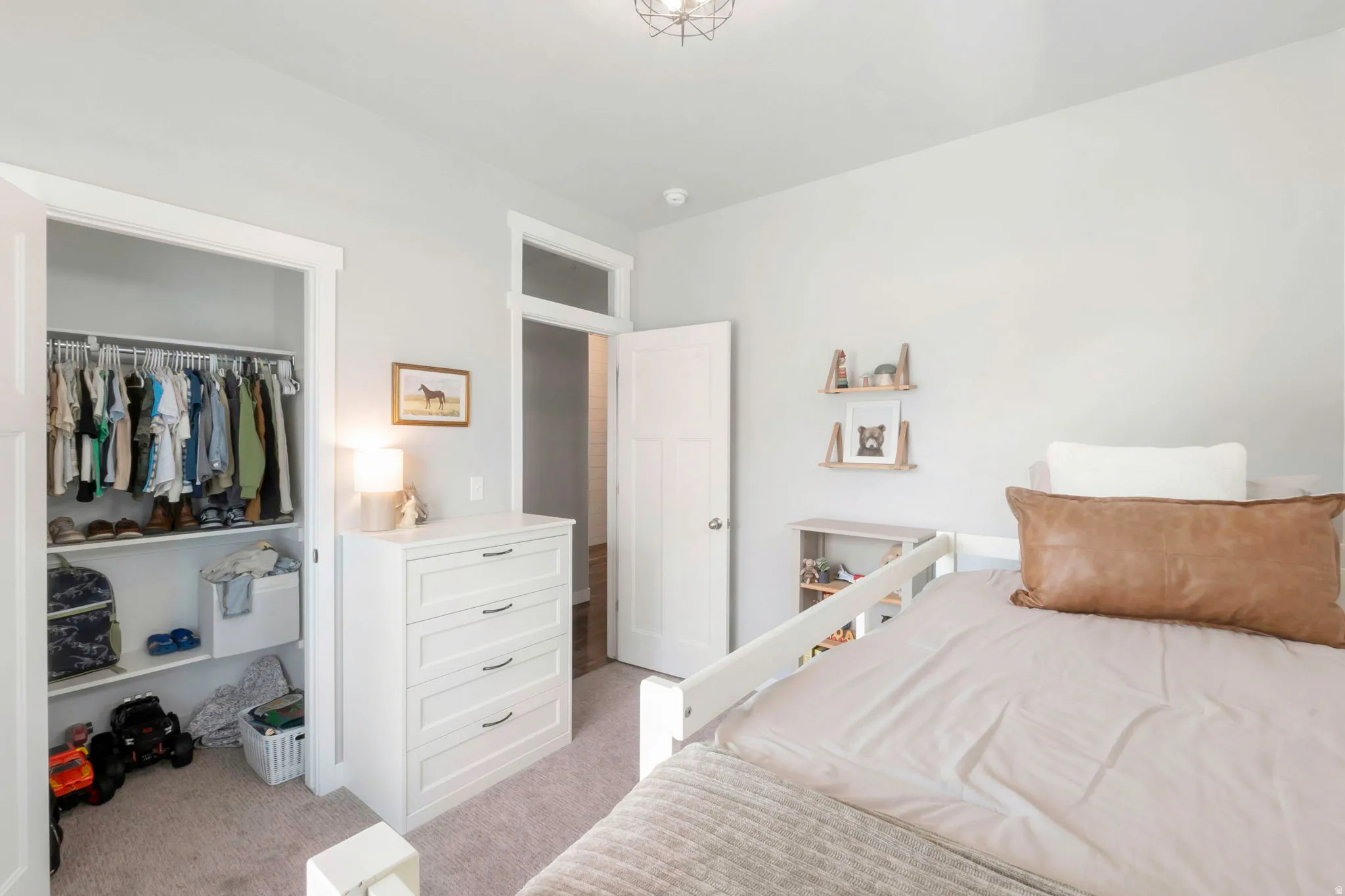 Bedroom featuring light colored carpet and a closet