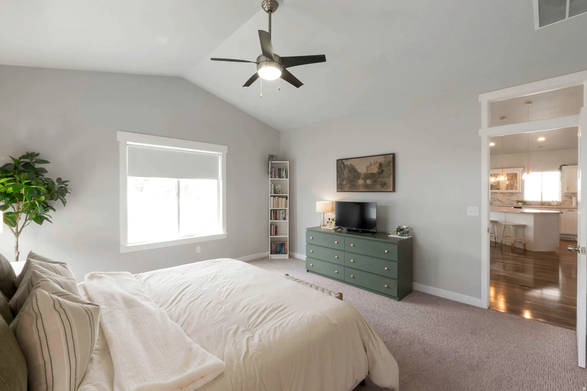 Carpeted bedroom featuring baseboards and ceiling fan