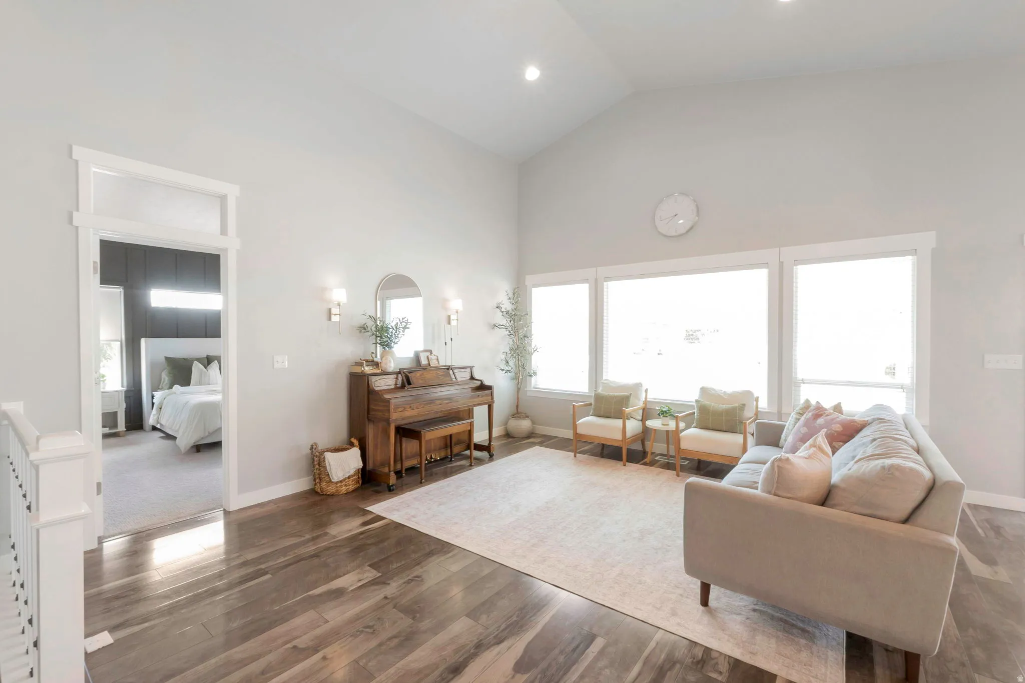 Living room featuring vaulted ceiling and wood finished floors
