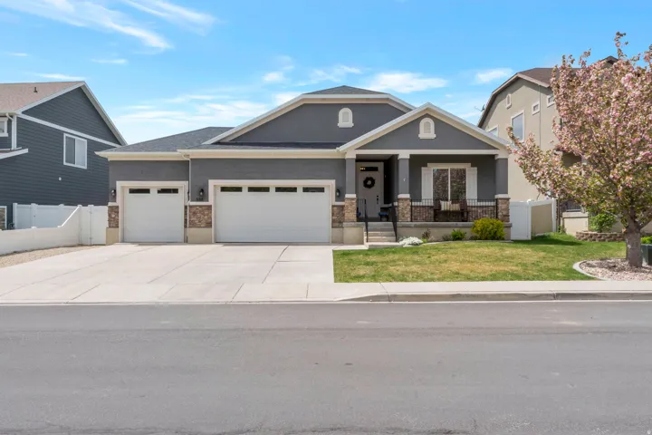 Craftsman-style house featuring a porch, an attached garage, concrete driveway, stucco siding, and a shingled roof