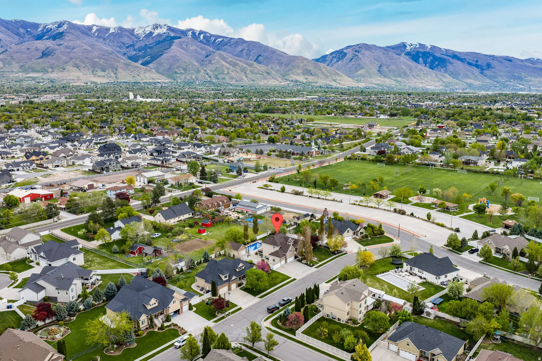 Aerial perspective of suburban area featuring a mountainous background