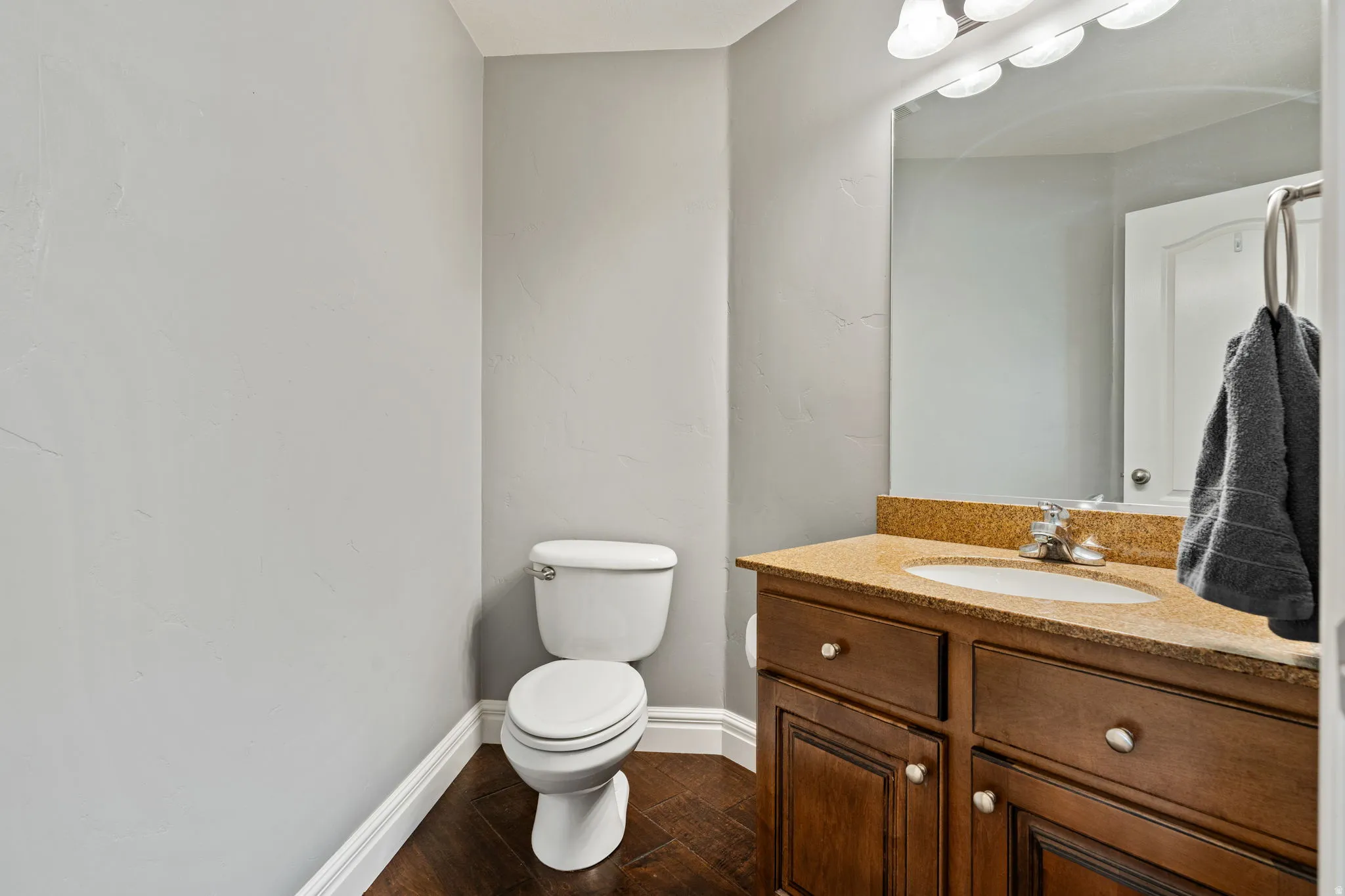 Bathroom with vanity and dark wood-style floors