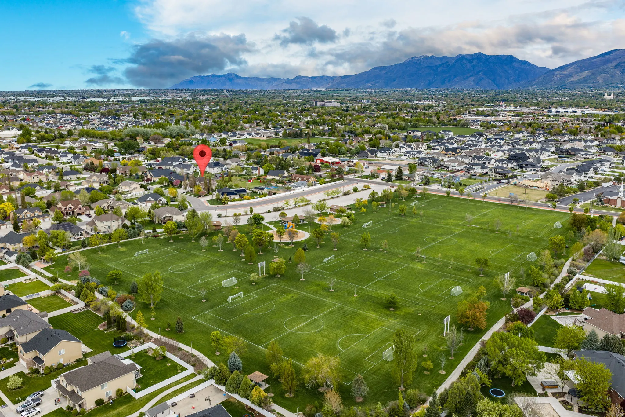 Aerial perspective of suburban area with a mountainous background