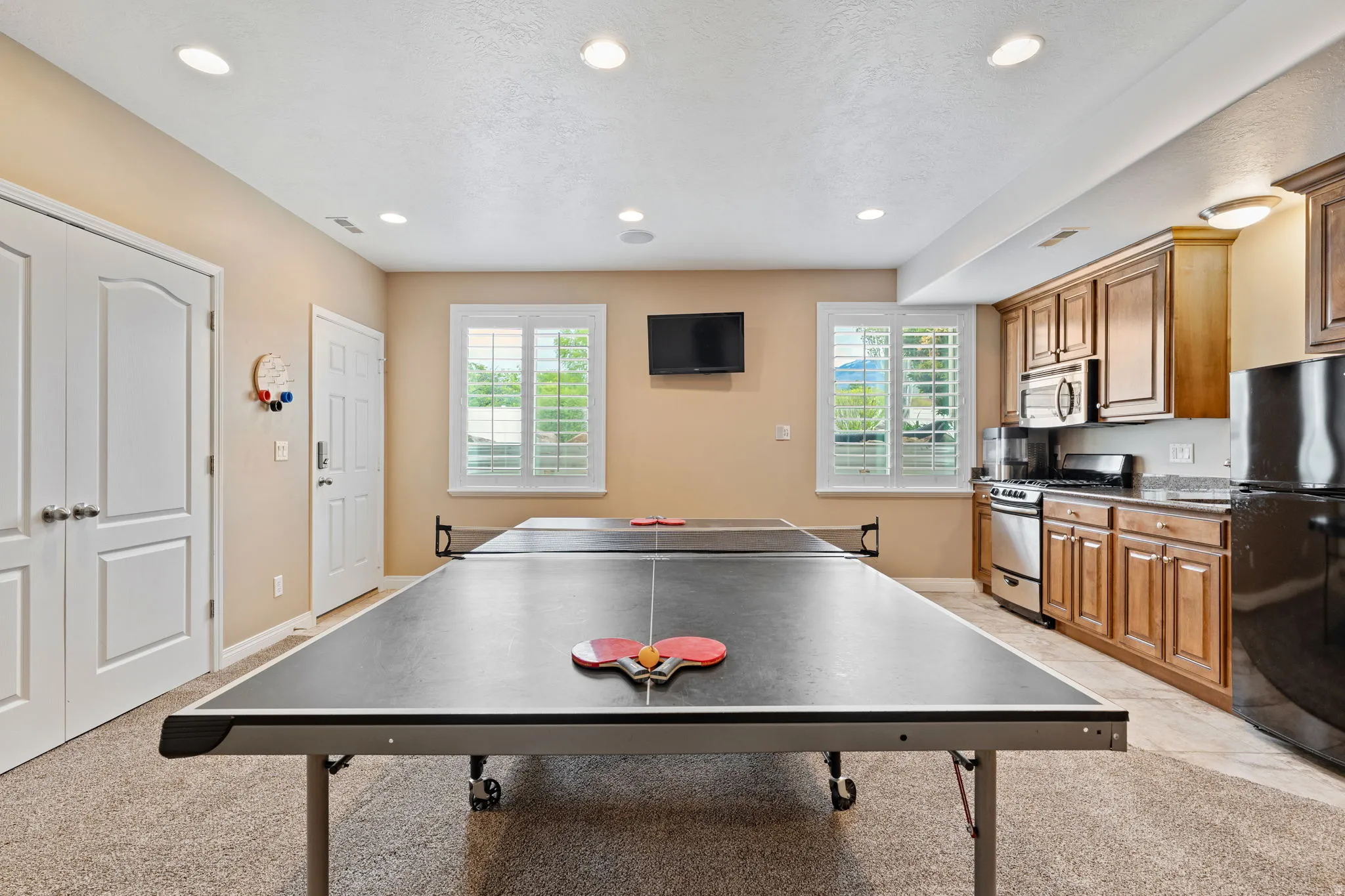 Recreation room featuring light carpet and recessed lighting