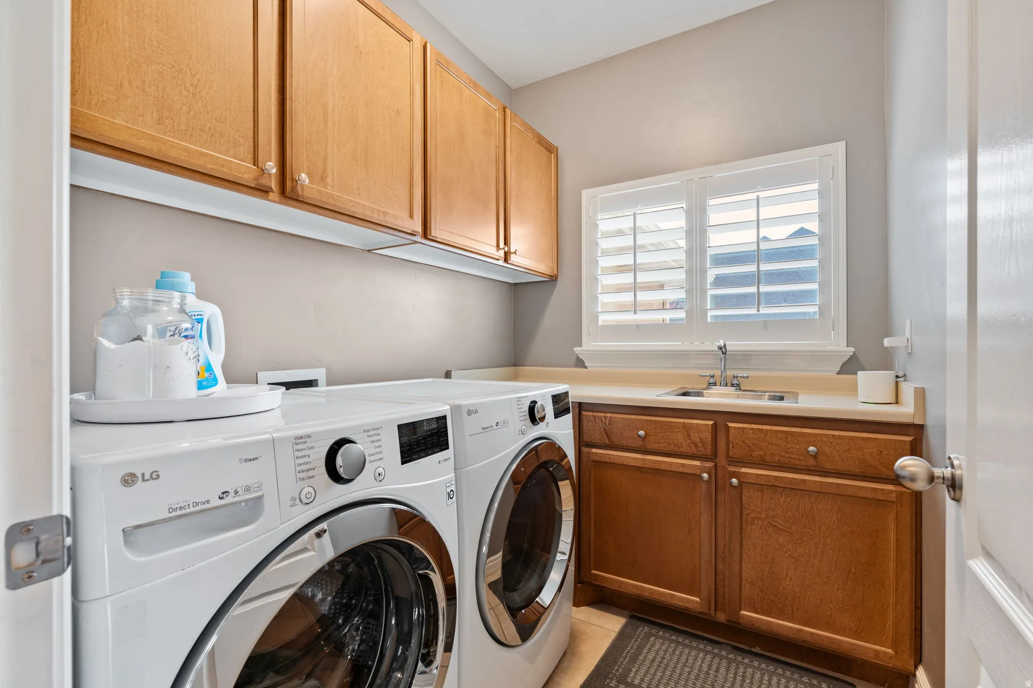 Laundry room featuring cabinet space, separate washer and dryer