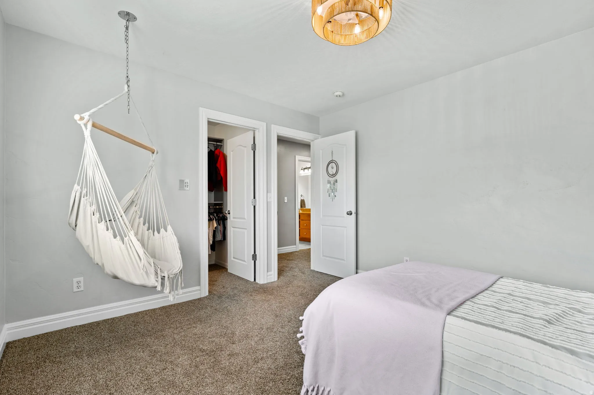 Bedroom with a spacious closet and carpet