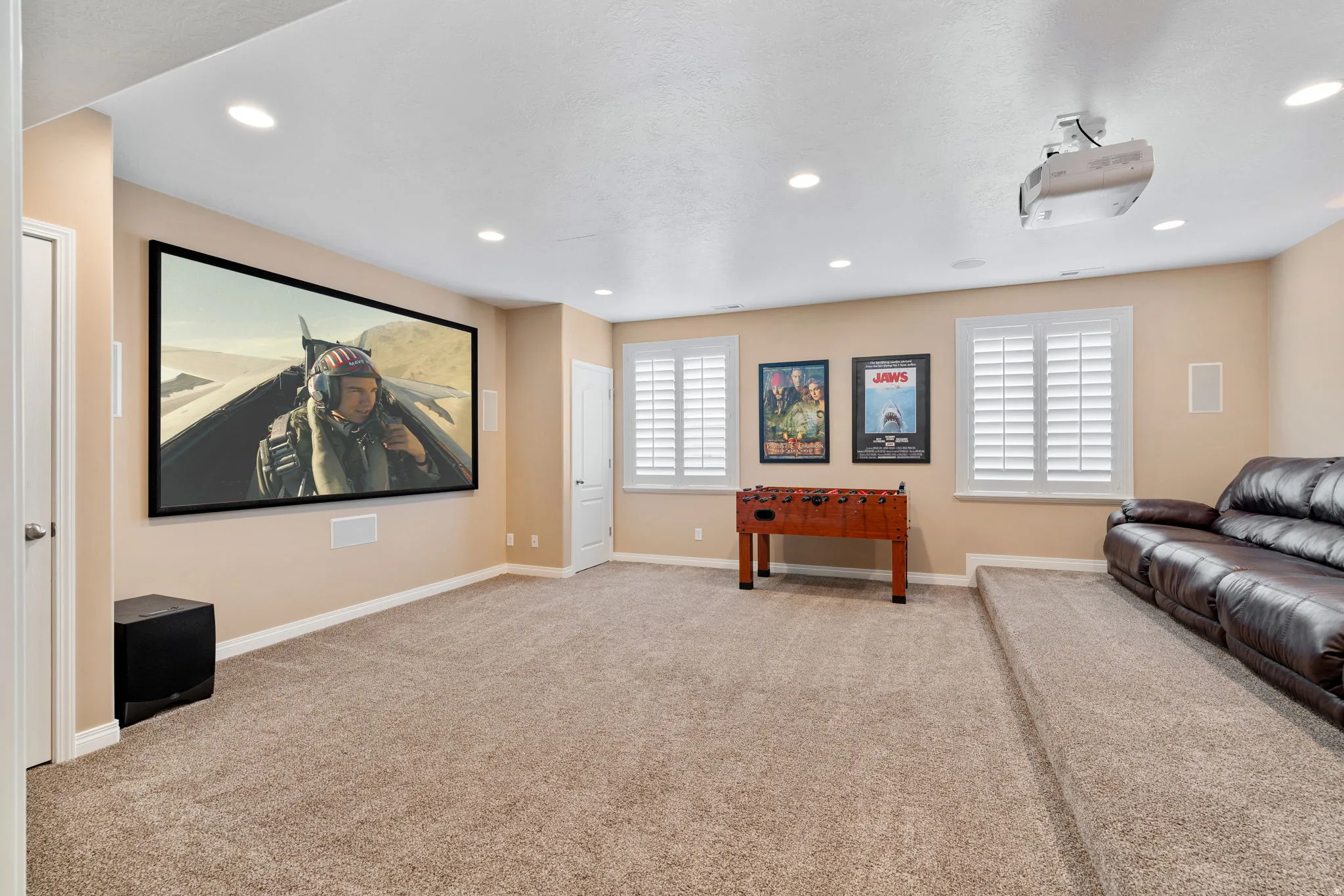 Home theater featuring light carpet and recessed lighting