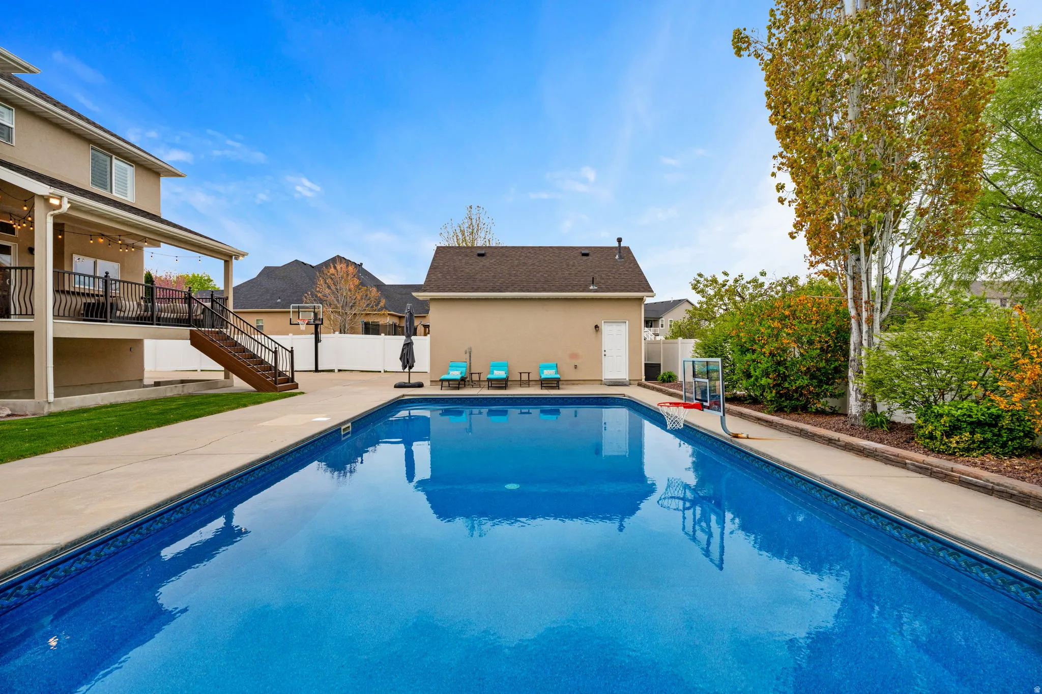 View of pool featuring patio surround and a fenced backyard