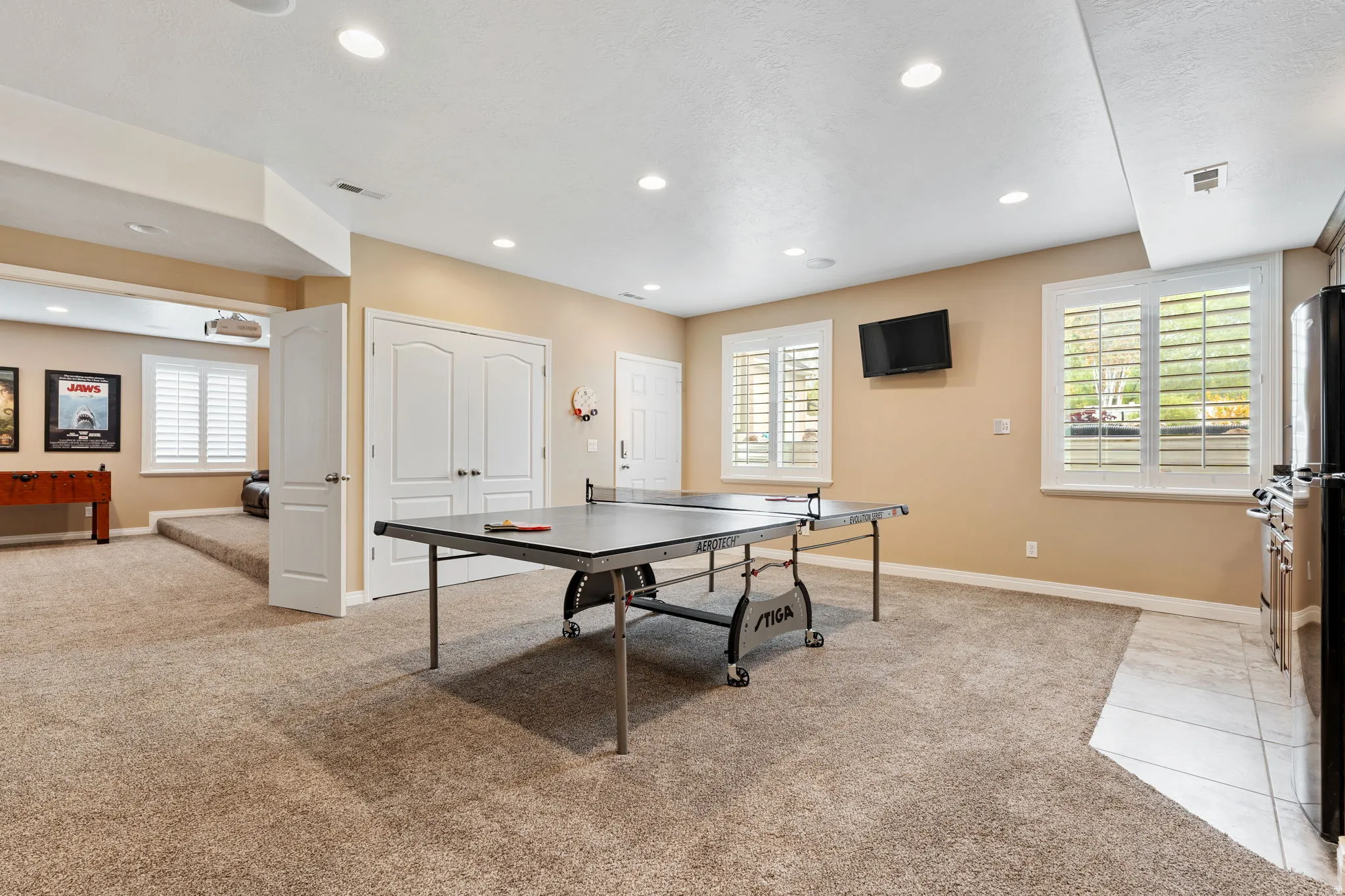 Game room with light colored carpet, healthy amount of natural light, and recessed lighting