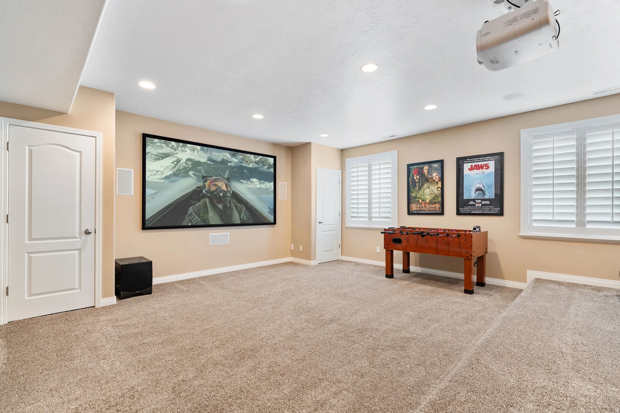Home theater featuring light colored carpet and recessed lighting