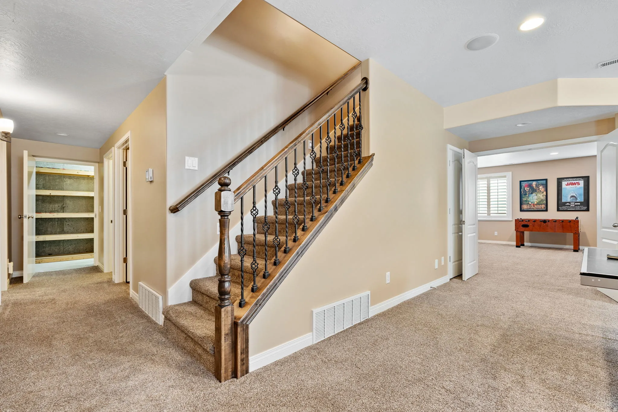 Stairway with carpet floors and recessed lighting