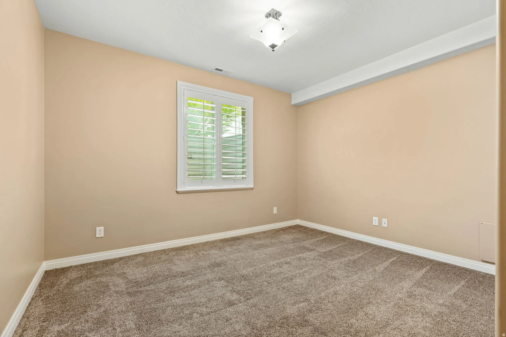 Unfurnished room with light colored carpet