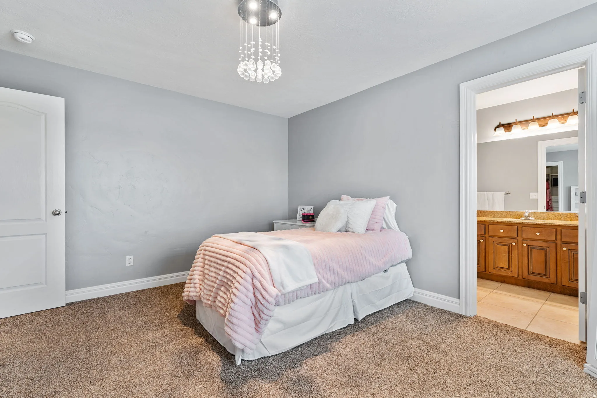 Bedroom featuring carpet flooring, connected bathroom, and tile patterned floors