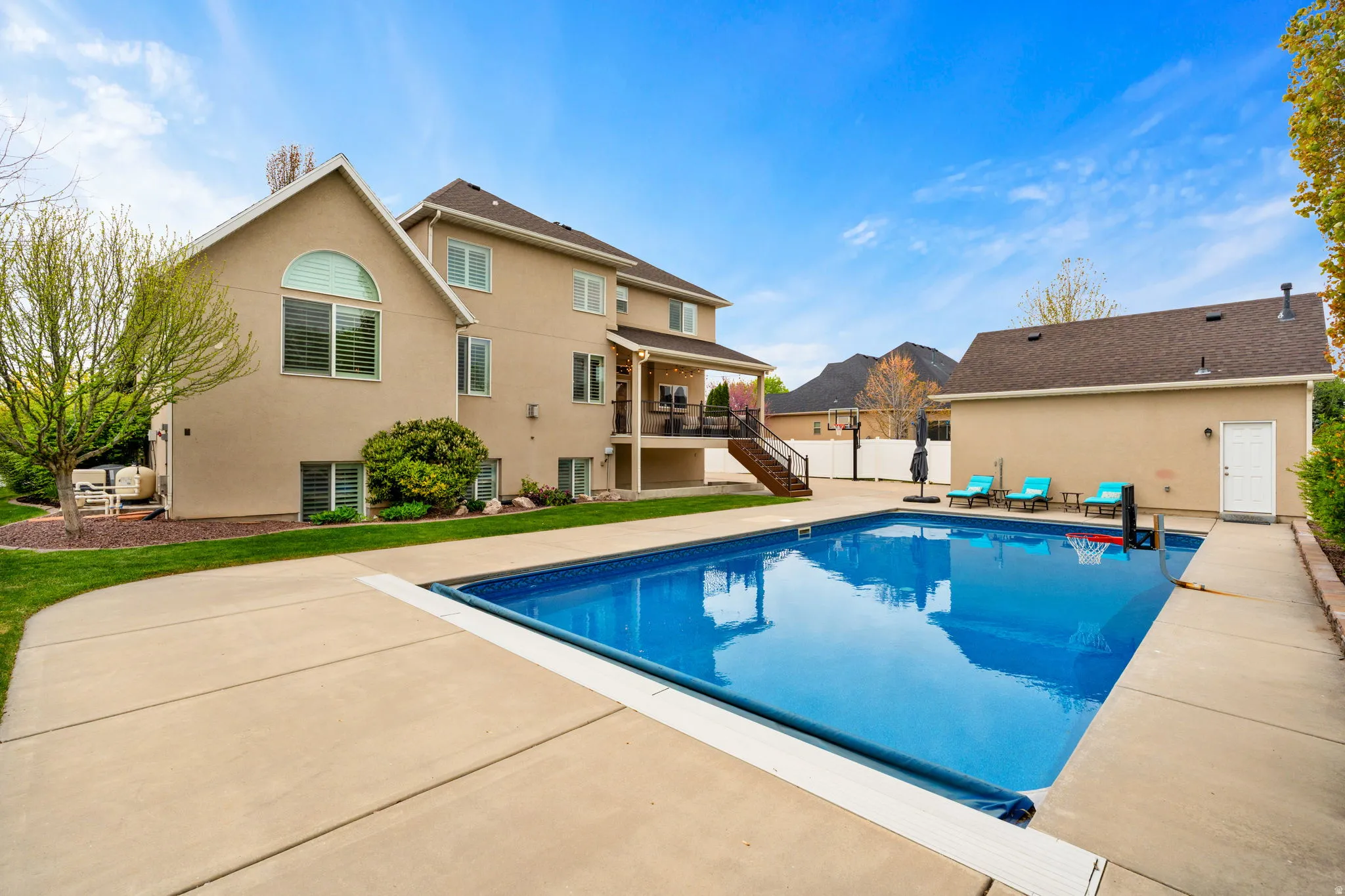 View of pool with patio surround and a deck
