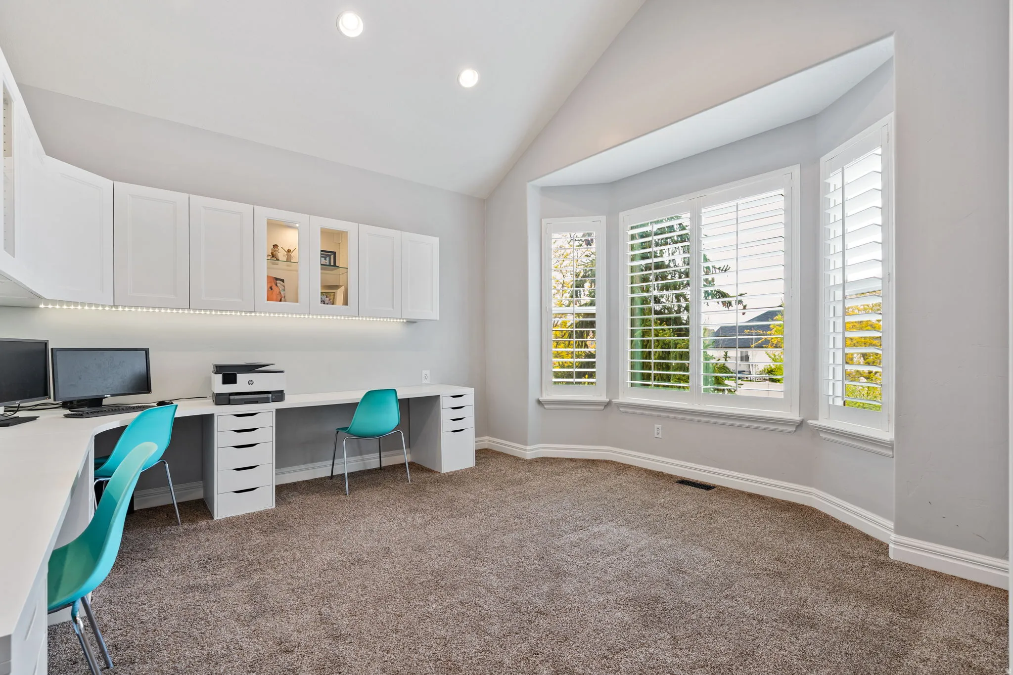 Office featuring vaulted ceiling, dark colored carpet, and recessed lighting