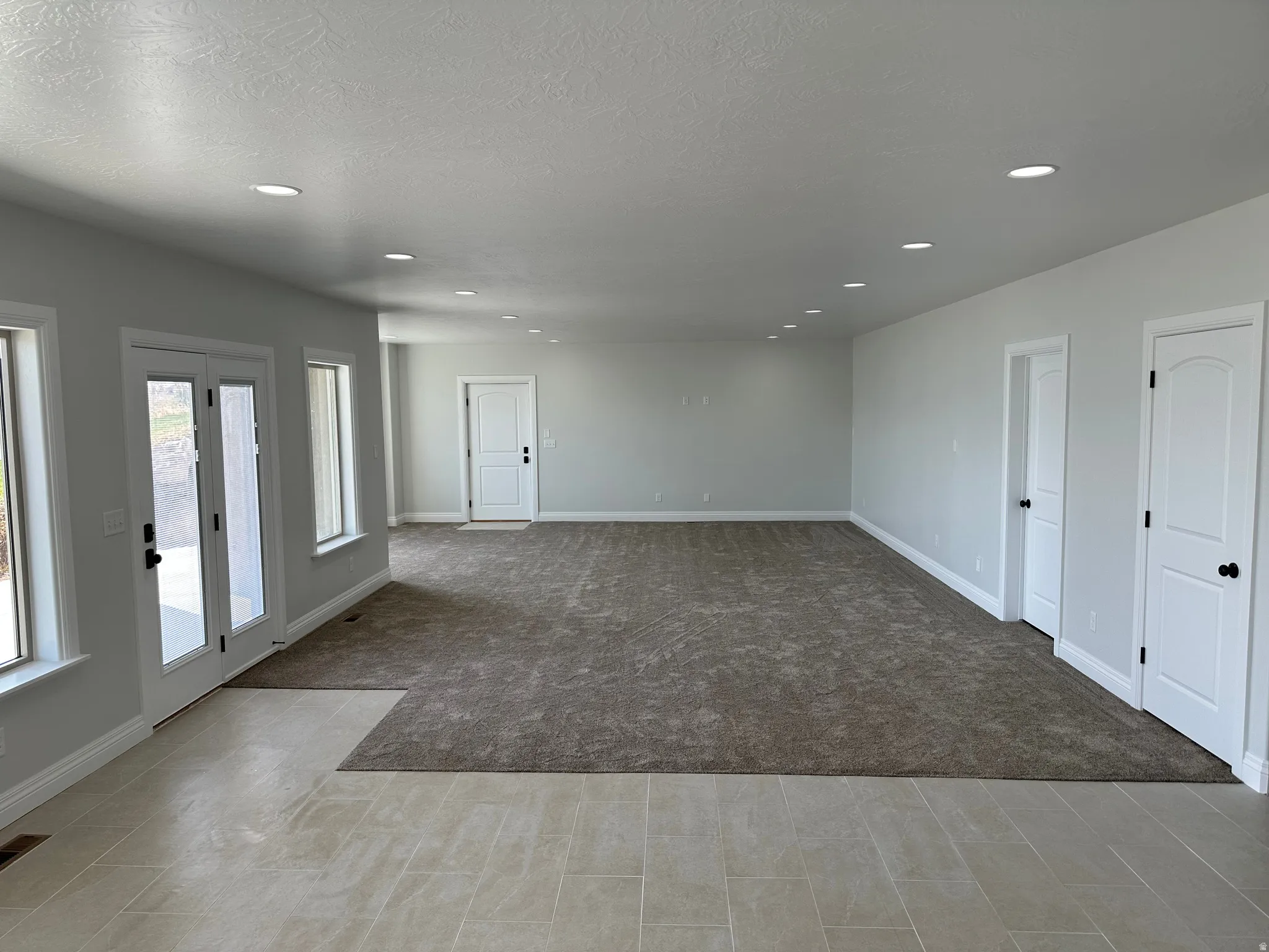Theatre Roo/Family room. Unfurnished room featuring light colored carpet, recessed lighting, and a textured ceiling