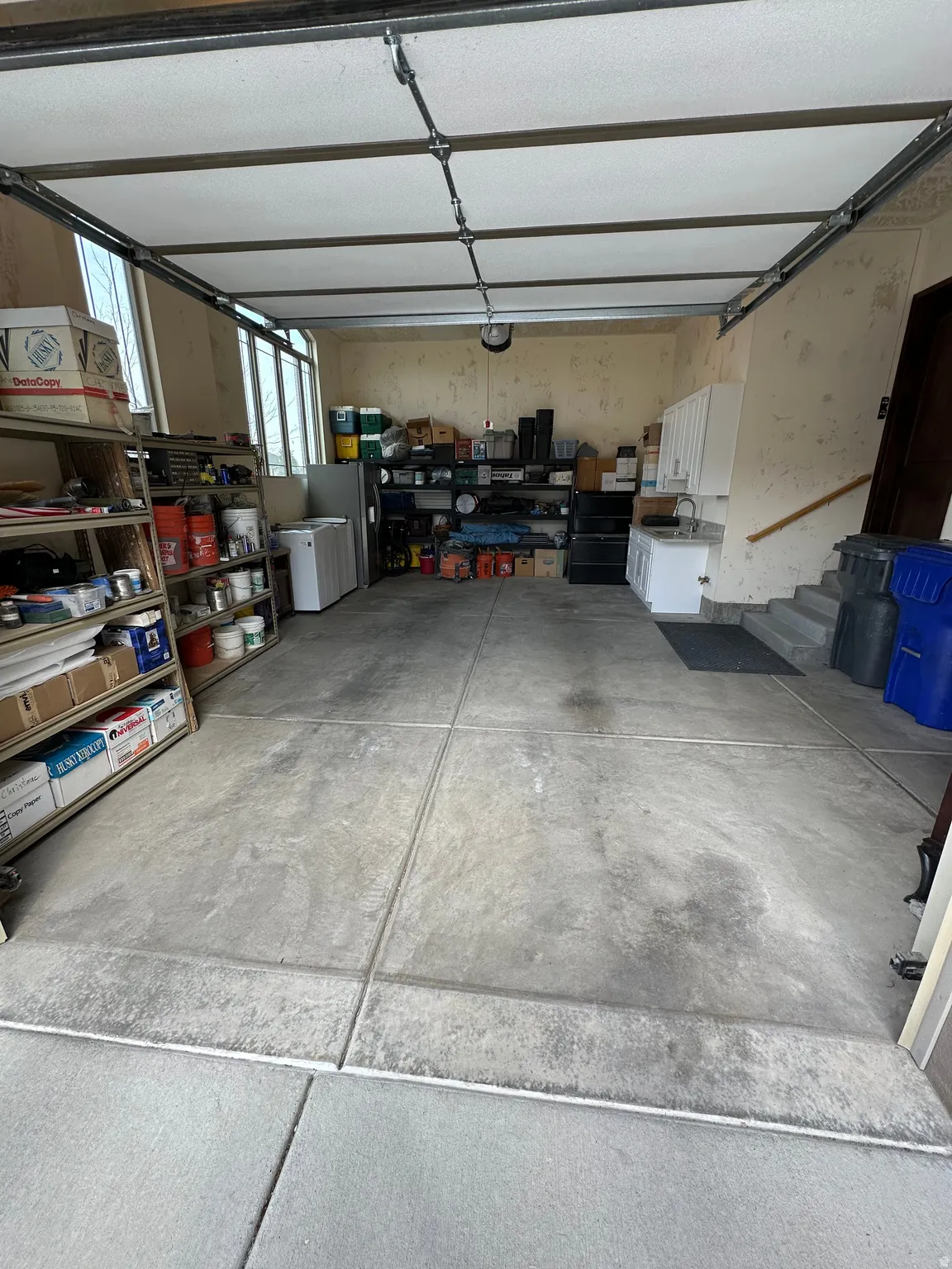 Garage featuring freestanding refrigerator