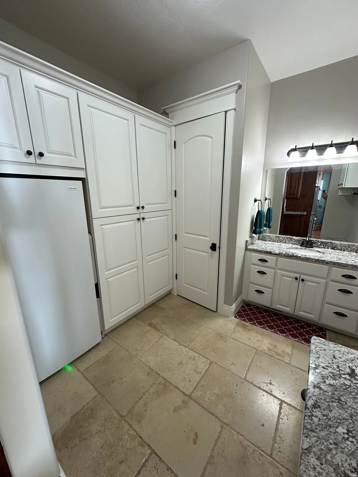 Bathroom with stone tile floors and vanity