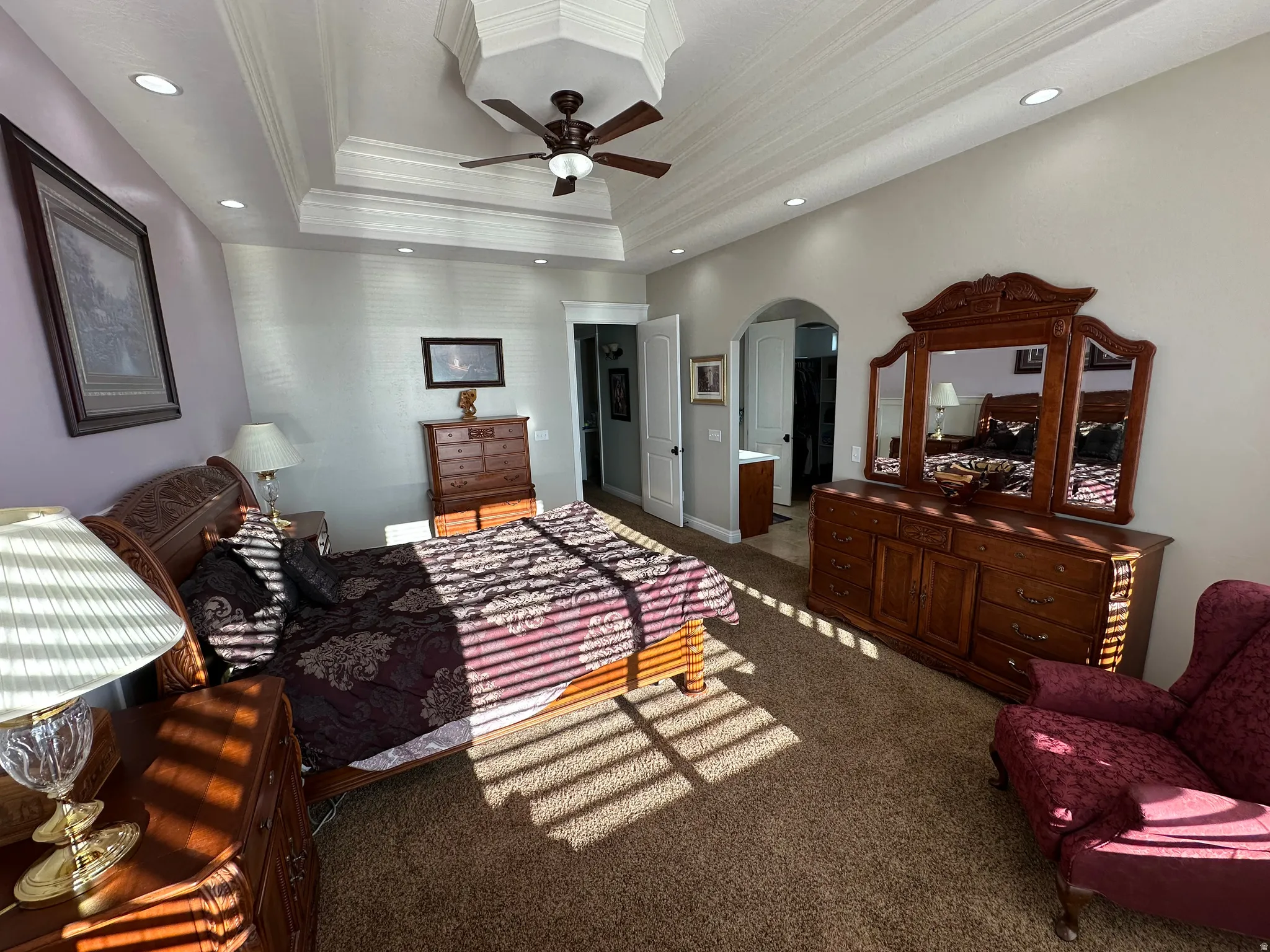 Bedroom with arched walkways, carpet, ornamental molding, a ceiling fan, and recessed lighting