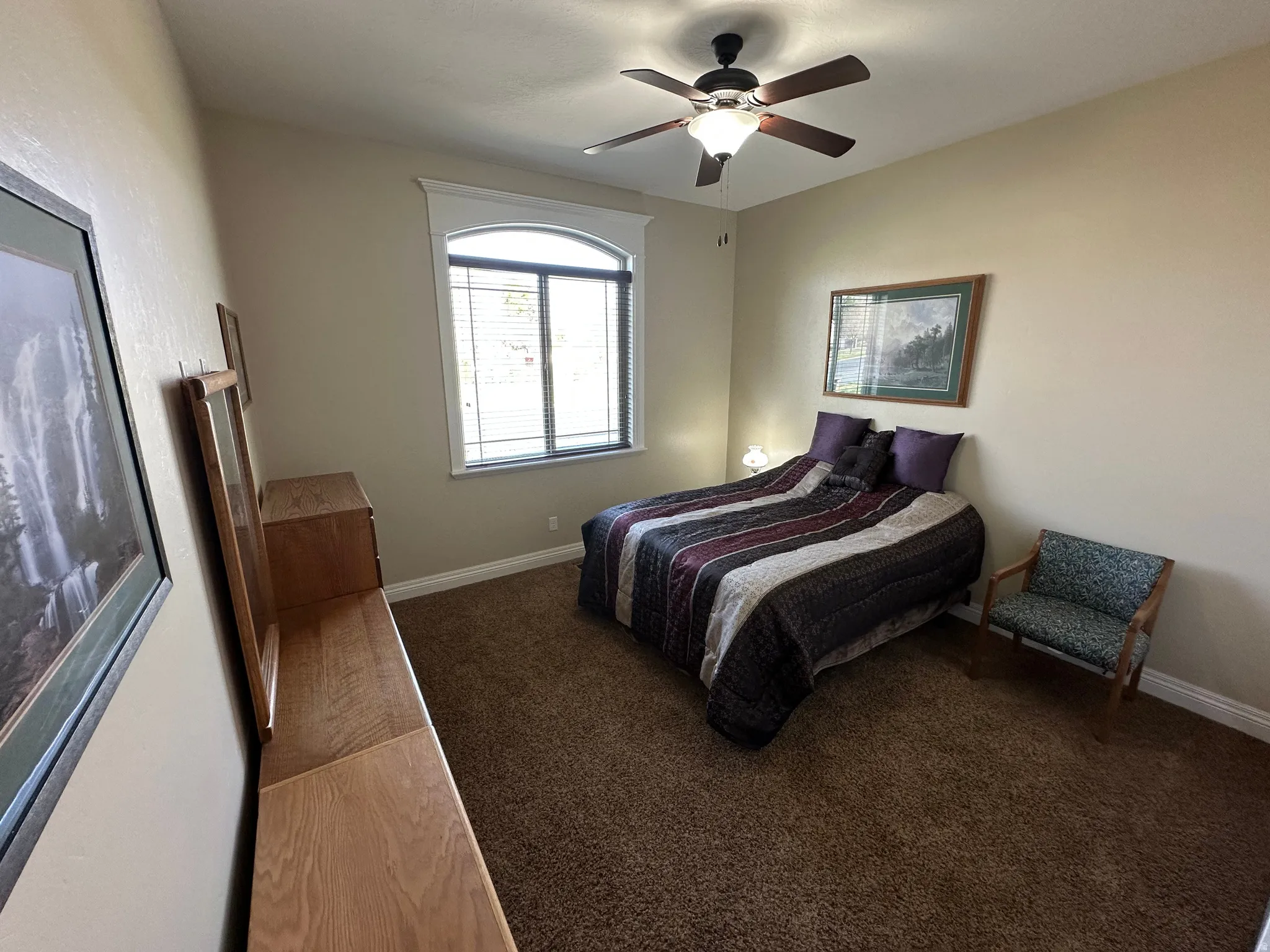 Bedroom featuring dark colored carpet and a ceiling fan